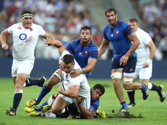 Nick Easter of England is tackled by Damien Chouley and Noa Nakaitaci at Stade de France on Saturday