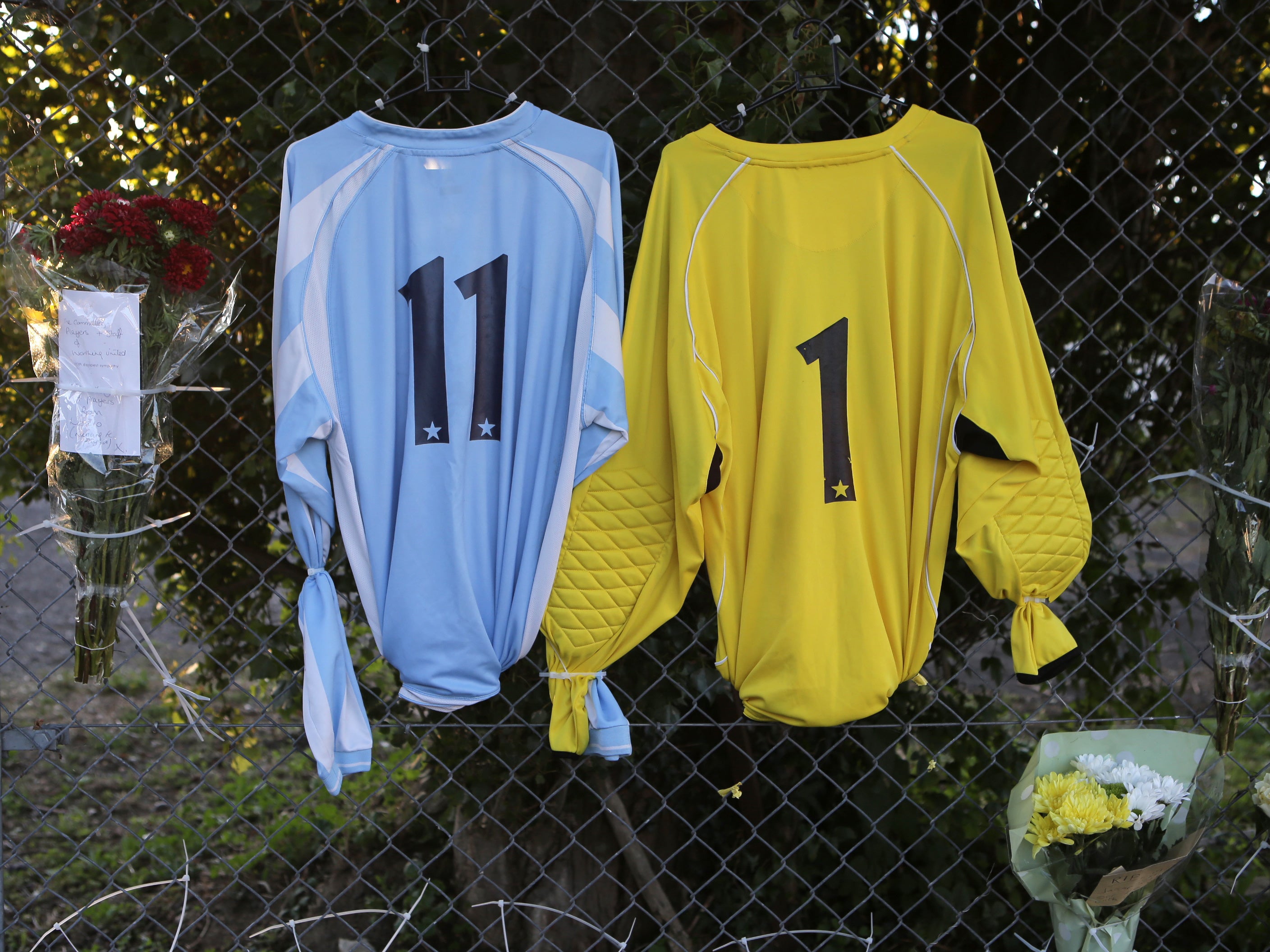 Team shirts and flowers are laid outside Worthing United Football Club where Matthew Grimstone and Jacob Schilt played