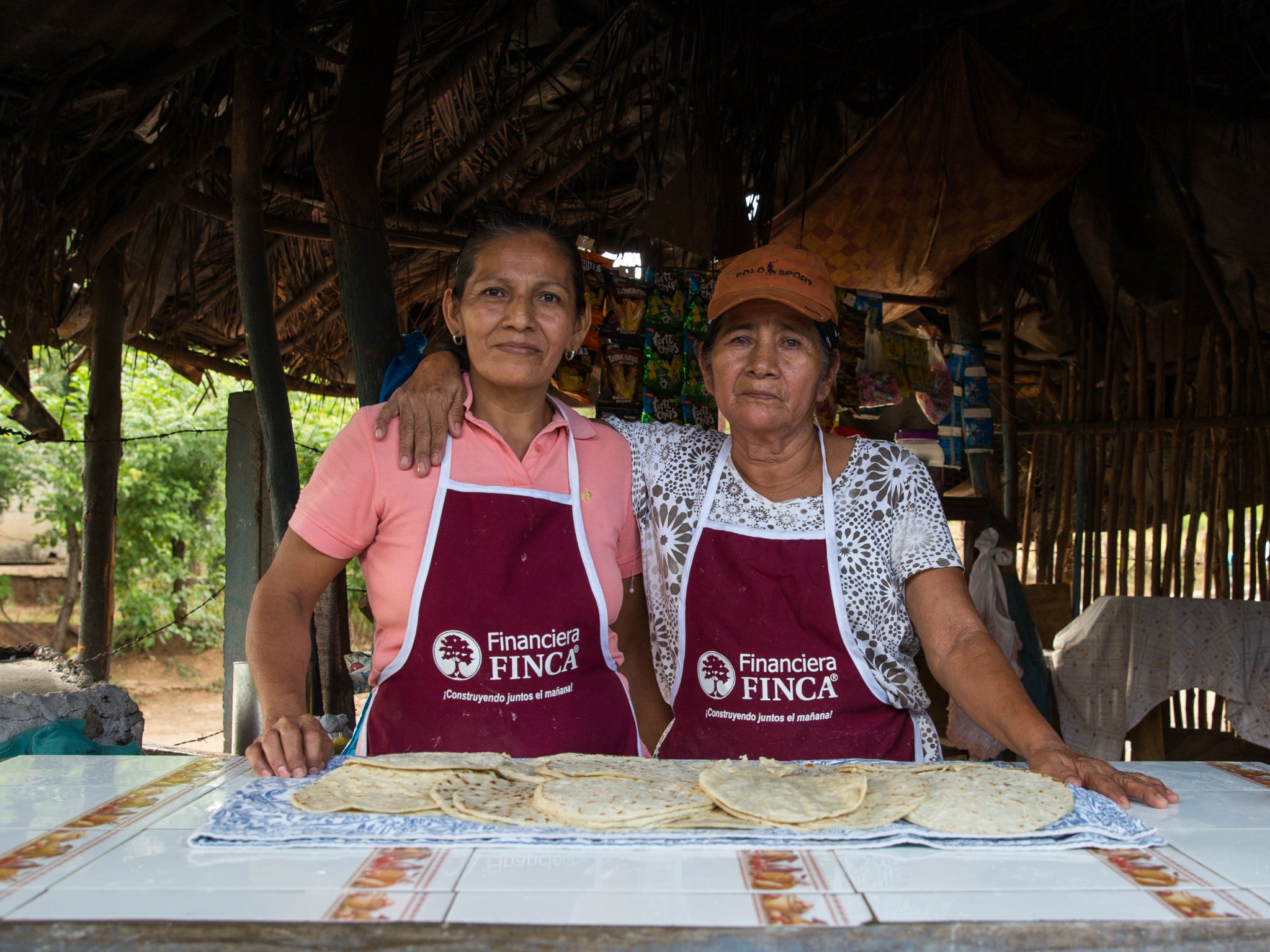 Julia and her daughter Isabel, get up at 4am and work till 5pm making and selling tortillas for the neighbourhood; the profits from the business have allowed Julia to buy a car.