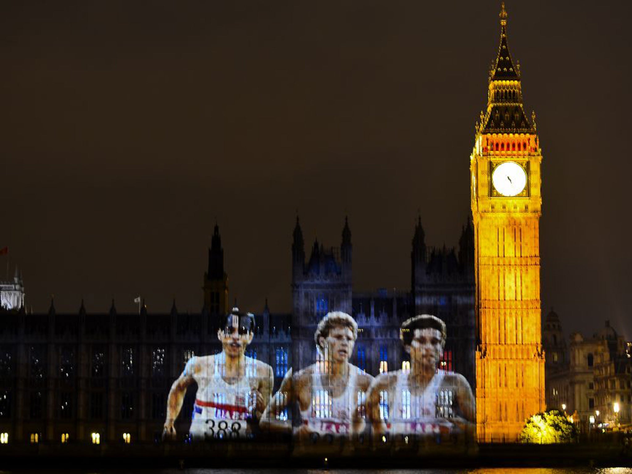 An image of the former British Olympians (left to right) Steve Ovett, Steve Cram and Sebastian Coe is projected on the Houses of Parliament during the summer opening ceremony of the London 2012 Olympic Games