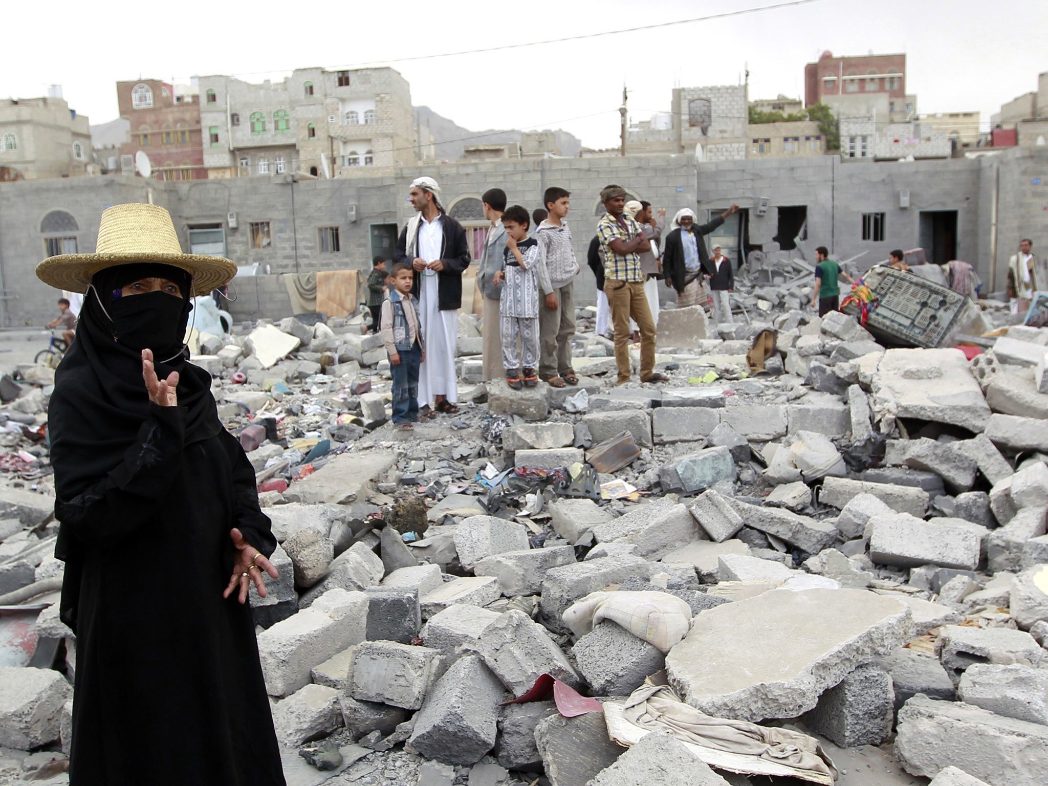 Yemenis stand amid the ruins of buildings destroyed in an air-strike by the Saudi-led coalition on the capital Sanaa. Yemen is classified as a fragile economy by the IMF.