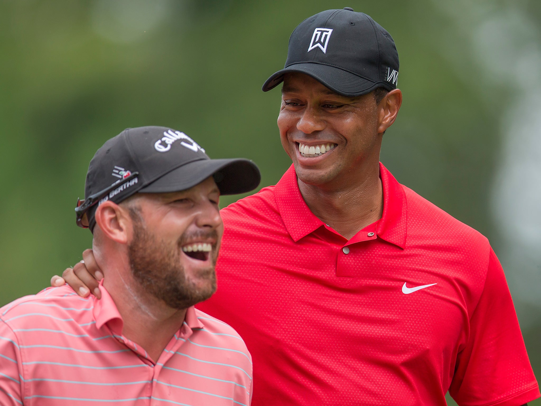 Tiger Woods congratulates his playing partner Scott Brown (left) after a hole-in-one