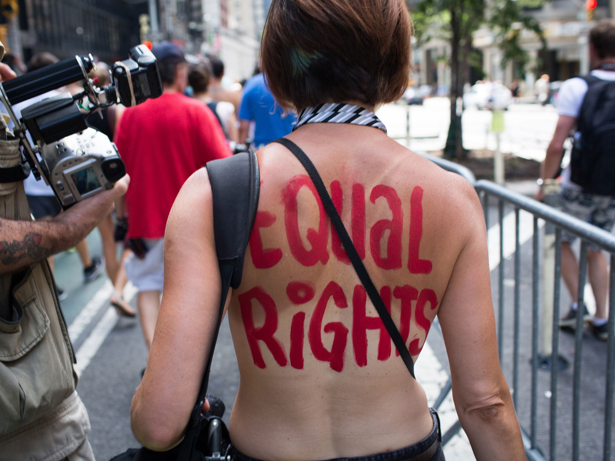 An activist marches in a protest march called the GoTopless Day Parade on Sunday, 23 August, 2015, in New York