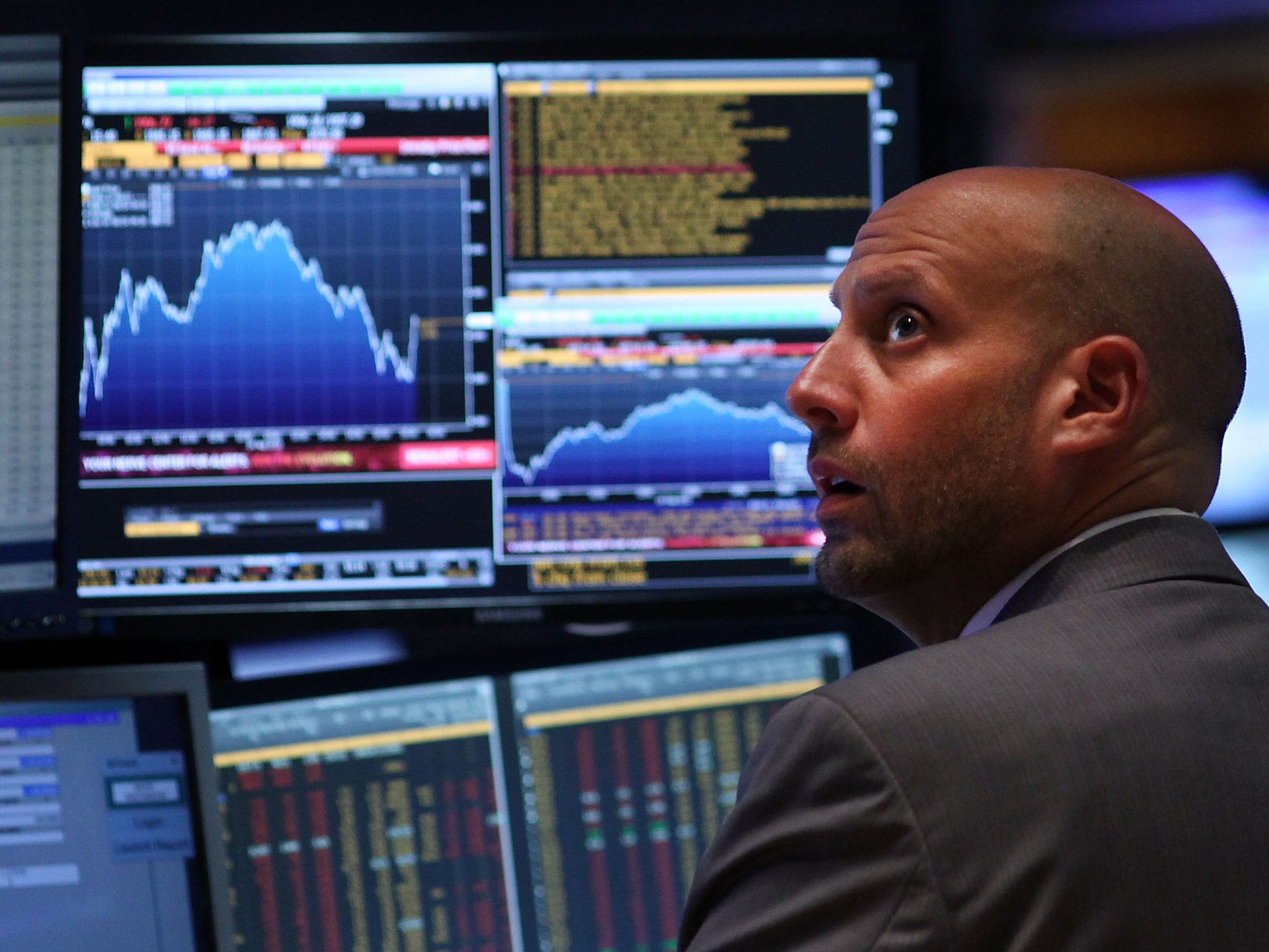 A trader works on the floor of the New York Stock Exchange (NYSE) on August 24, 2015 in New York City