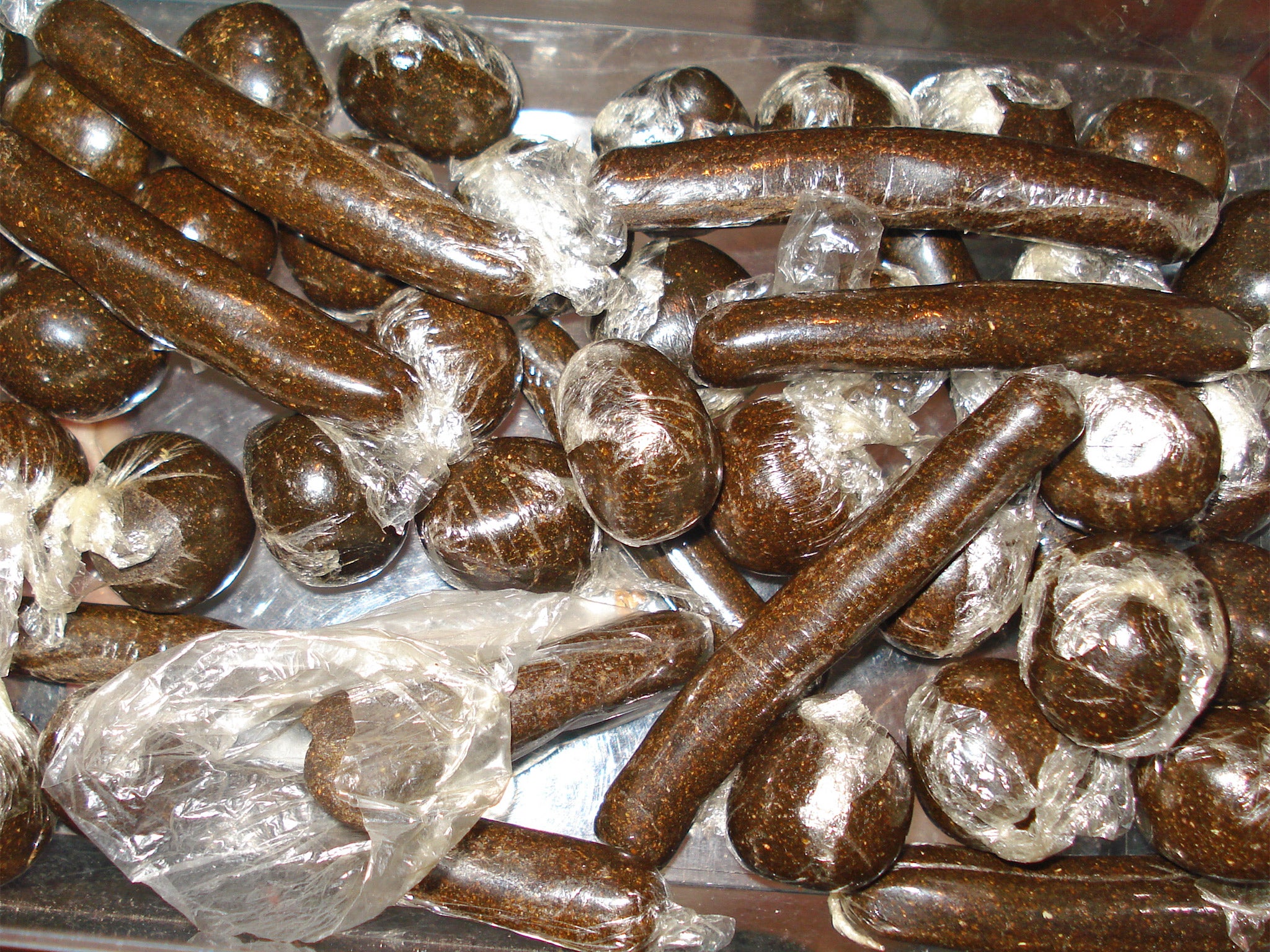 Balls and sticks of 'charas', which is made from the resin of the cannabis plant