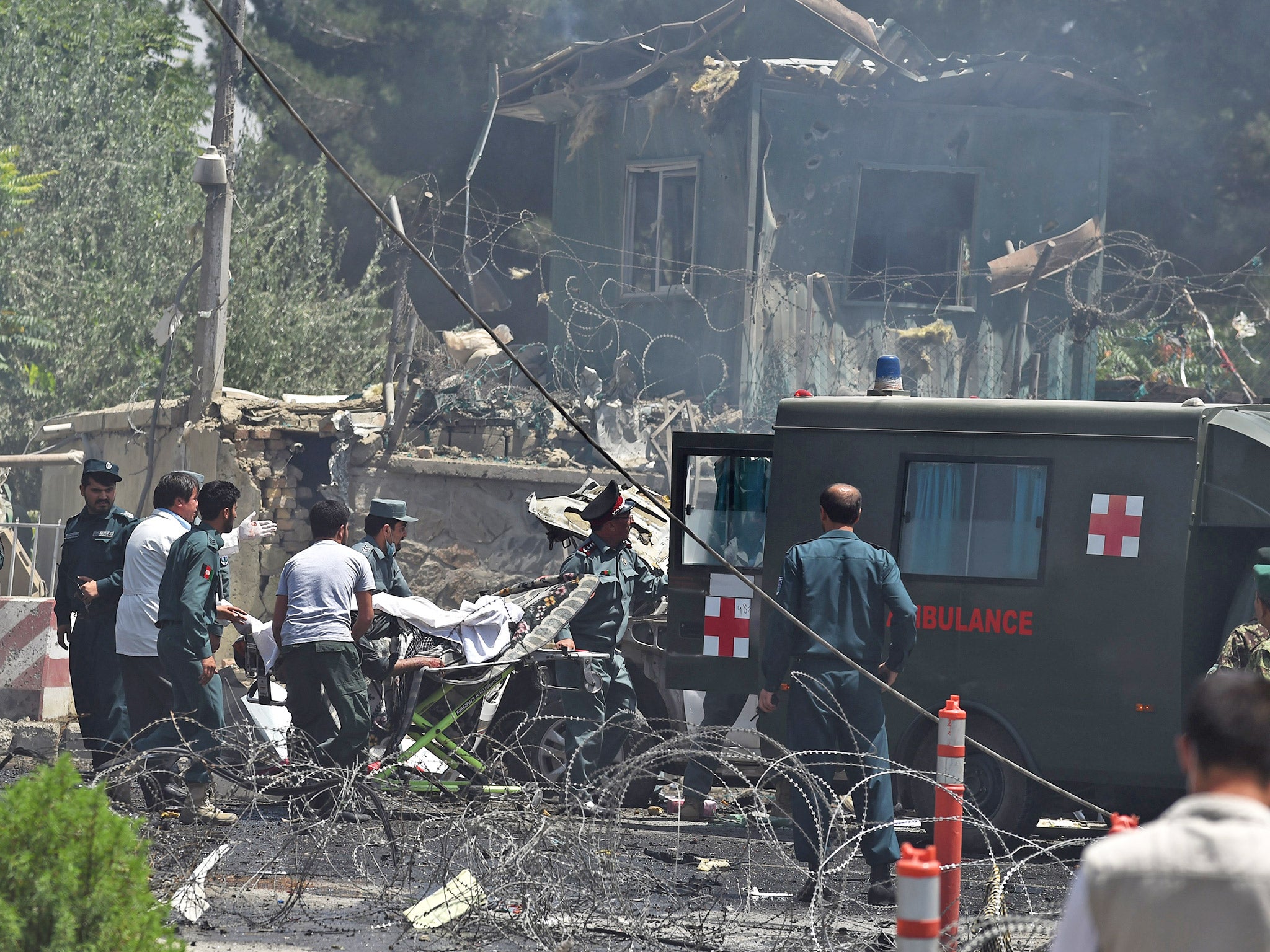 Afghan security forces carry a victim into a ambulance at the site of a Taliban suicide bomb attack near Kabul's international airport, earlier this month (Getty)