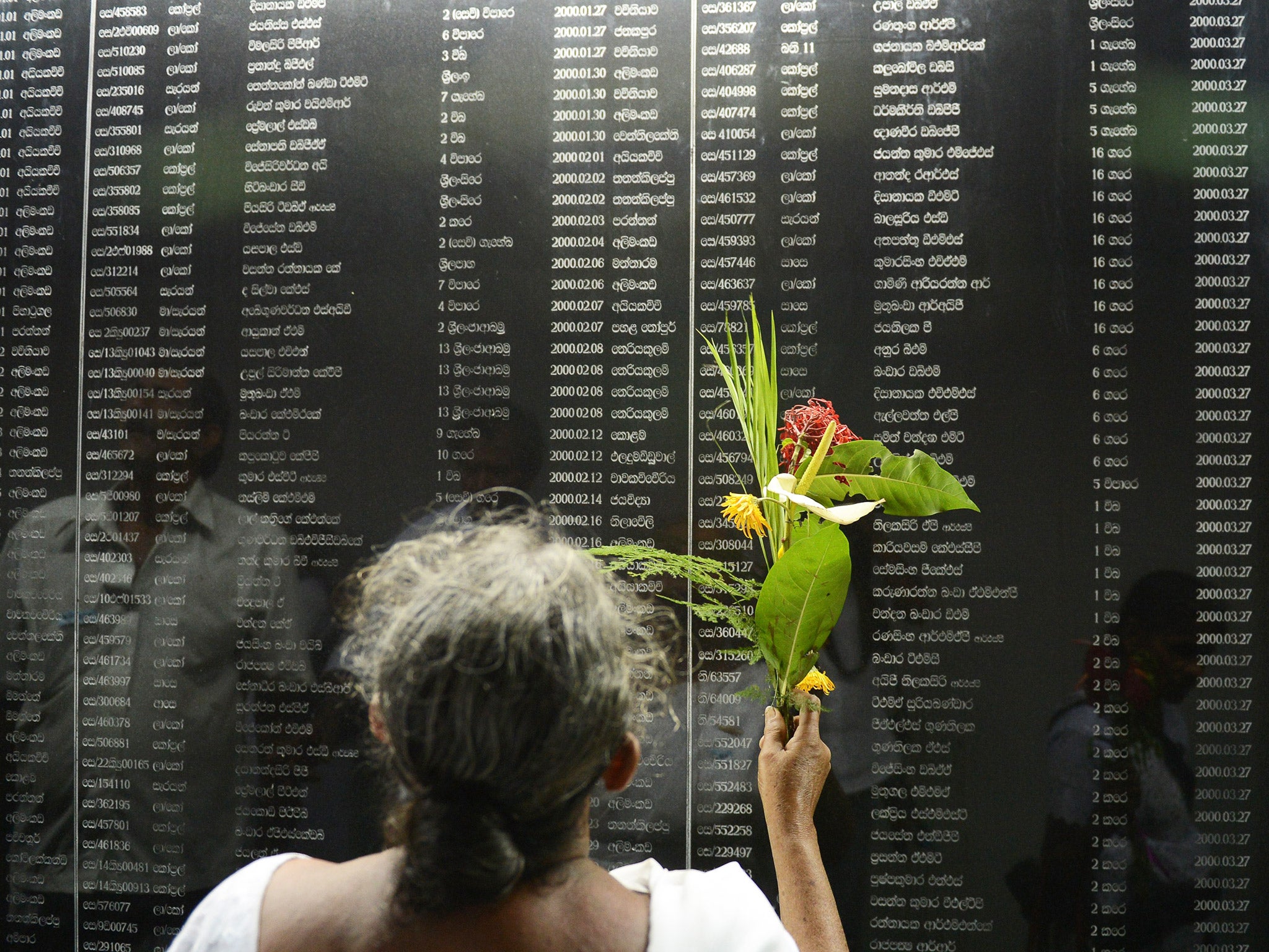 A Sri Lankan woman reads through names of fallen soldiers at a memorial in Colombo for those who died in the decades-long conflict against the Tamil Tigers (Getty)