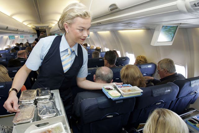 Flight attendant serving in the cabin of an aeroplane