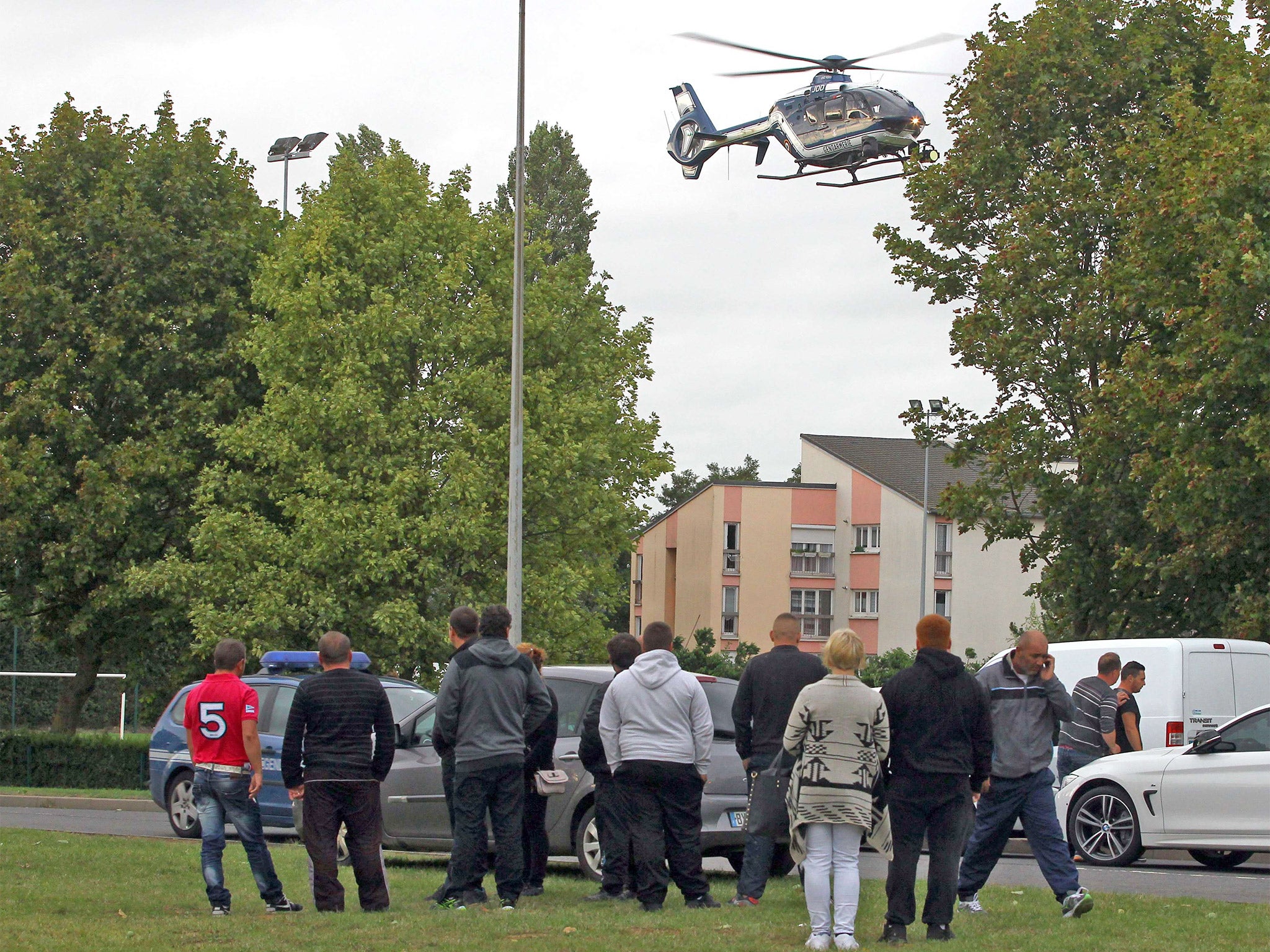A helicopter of Gendarmerie flies near the site of a shooting in Roye, northern France