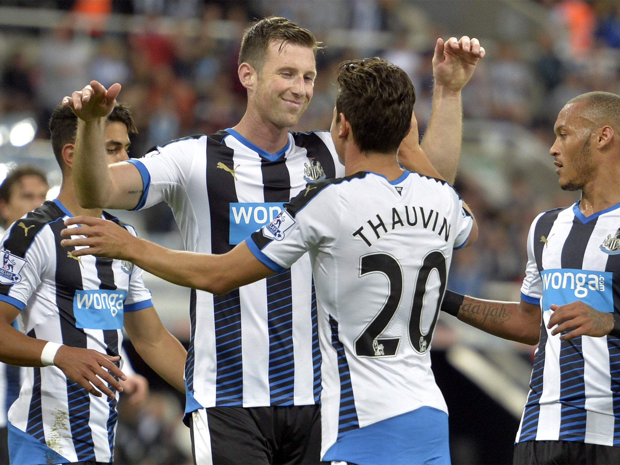 Mike Williamson and Florian Thauvin celebrate after Newcastle’s fourth goal