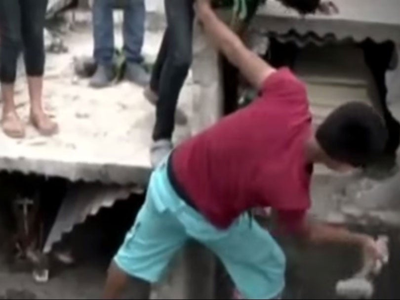Video showed relatives of Neysi Perez, from Honduras, desperately hammering at the concrete surrounding her coffin