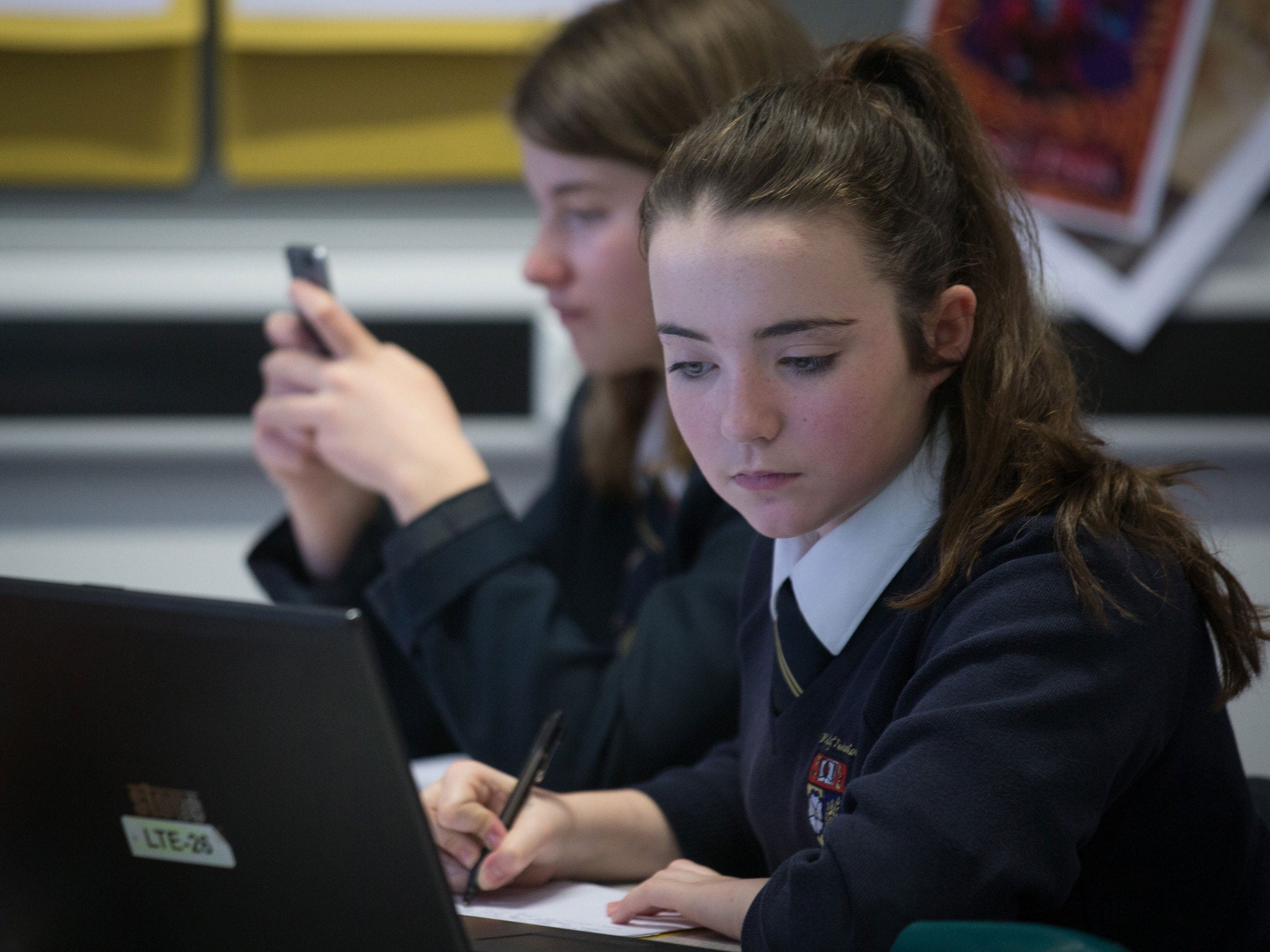 A pupil uses a laptop computer during a english lesson at the Ridings Federation Winterbourne International Academy in Winterbourne near Bristol on February 26, 2015 in South Gloucestershire, England