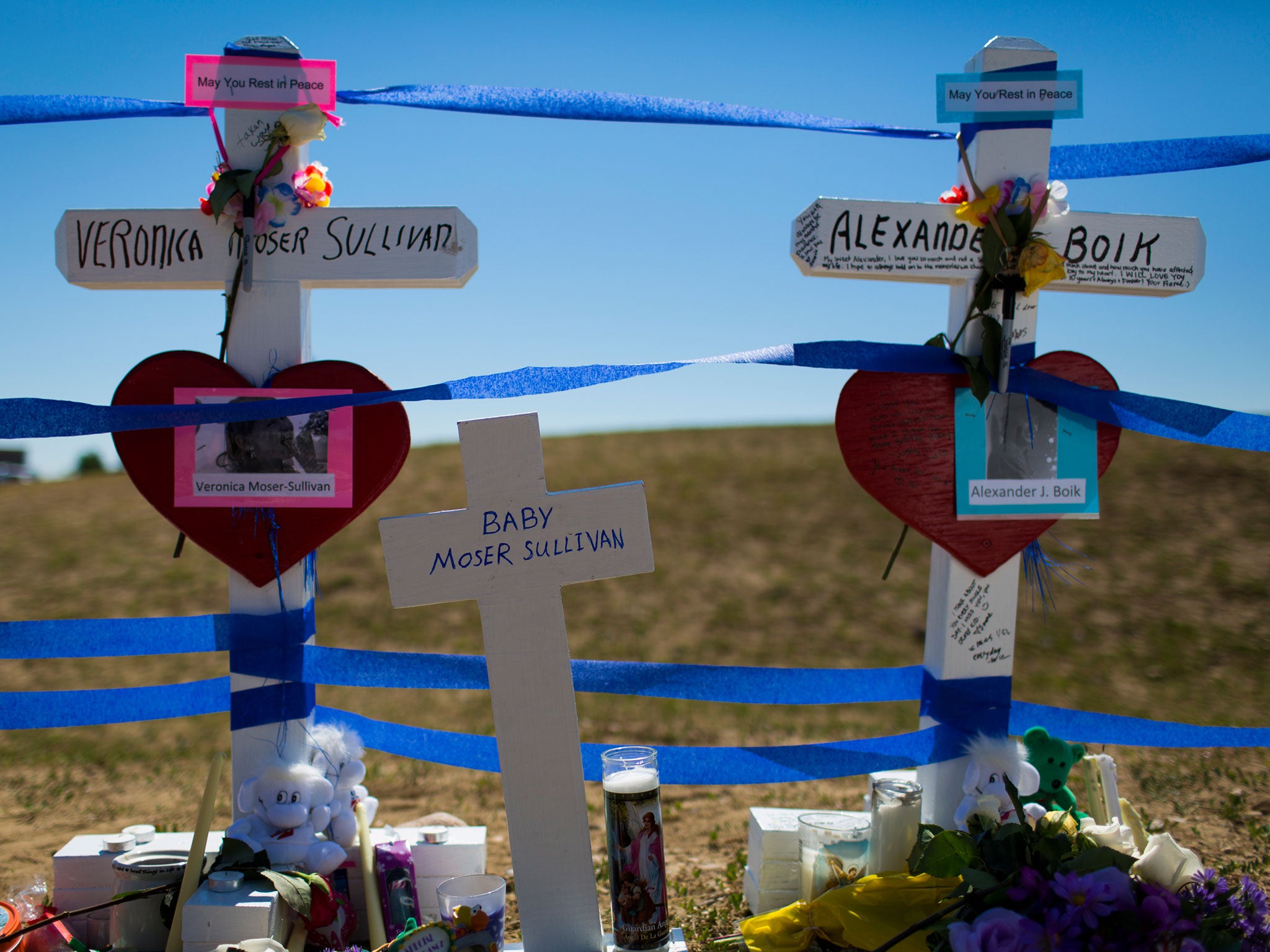 Community members erect twelve crosses at a remembrance ceremony = in Aurora (Image: Getty)