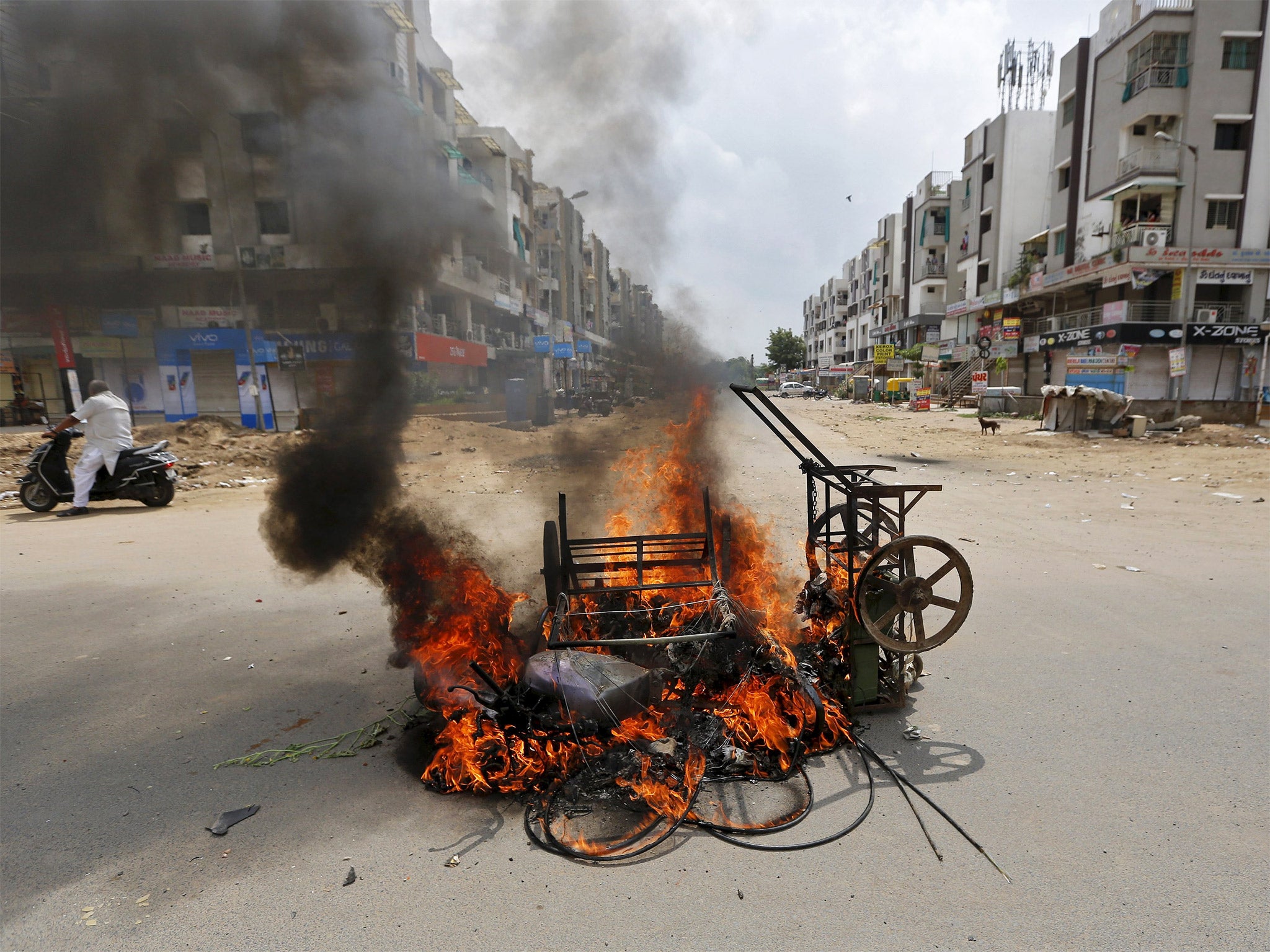 Vehicles burn after the clashes in Ahmadabad