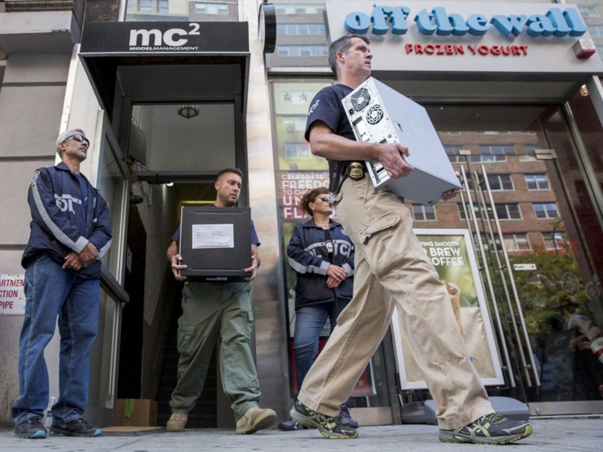 Law enforcement officers seize evidence from the Manhattan offices of Rentboy.com in New York