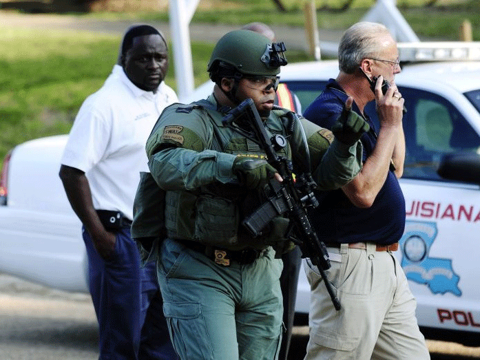 A Louisiana State Police SWAT officer responds to the barricade