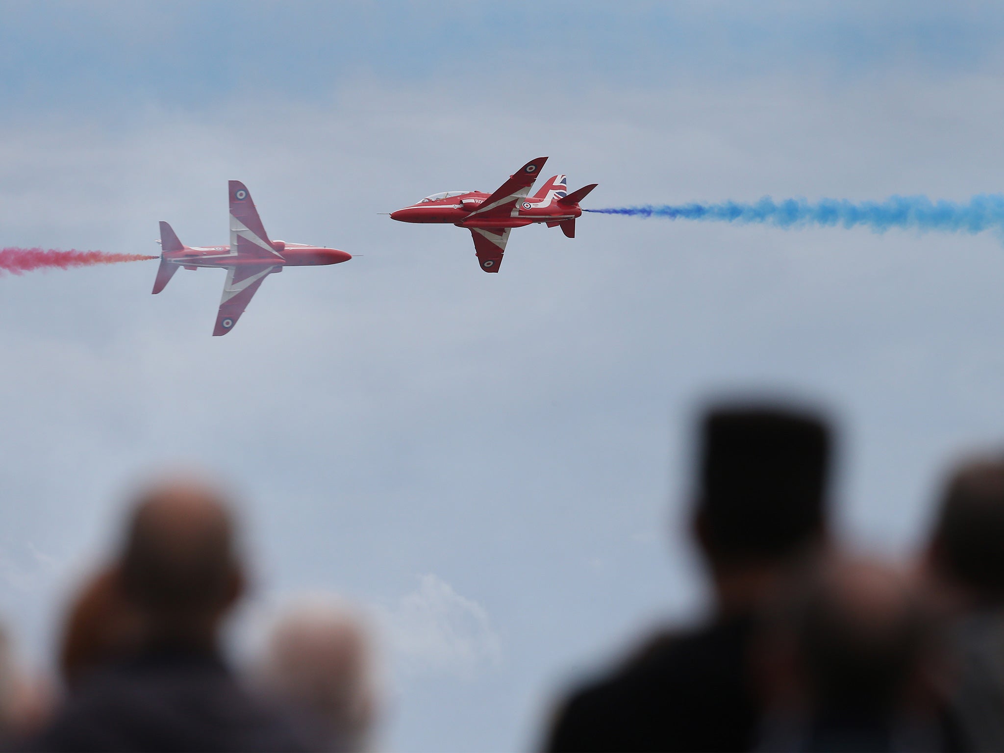 People watch as the RAF Red Arrows display team takes part in the Clacton Airshow