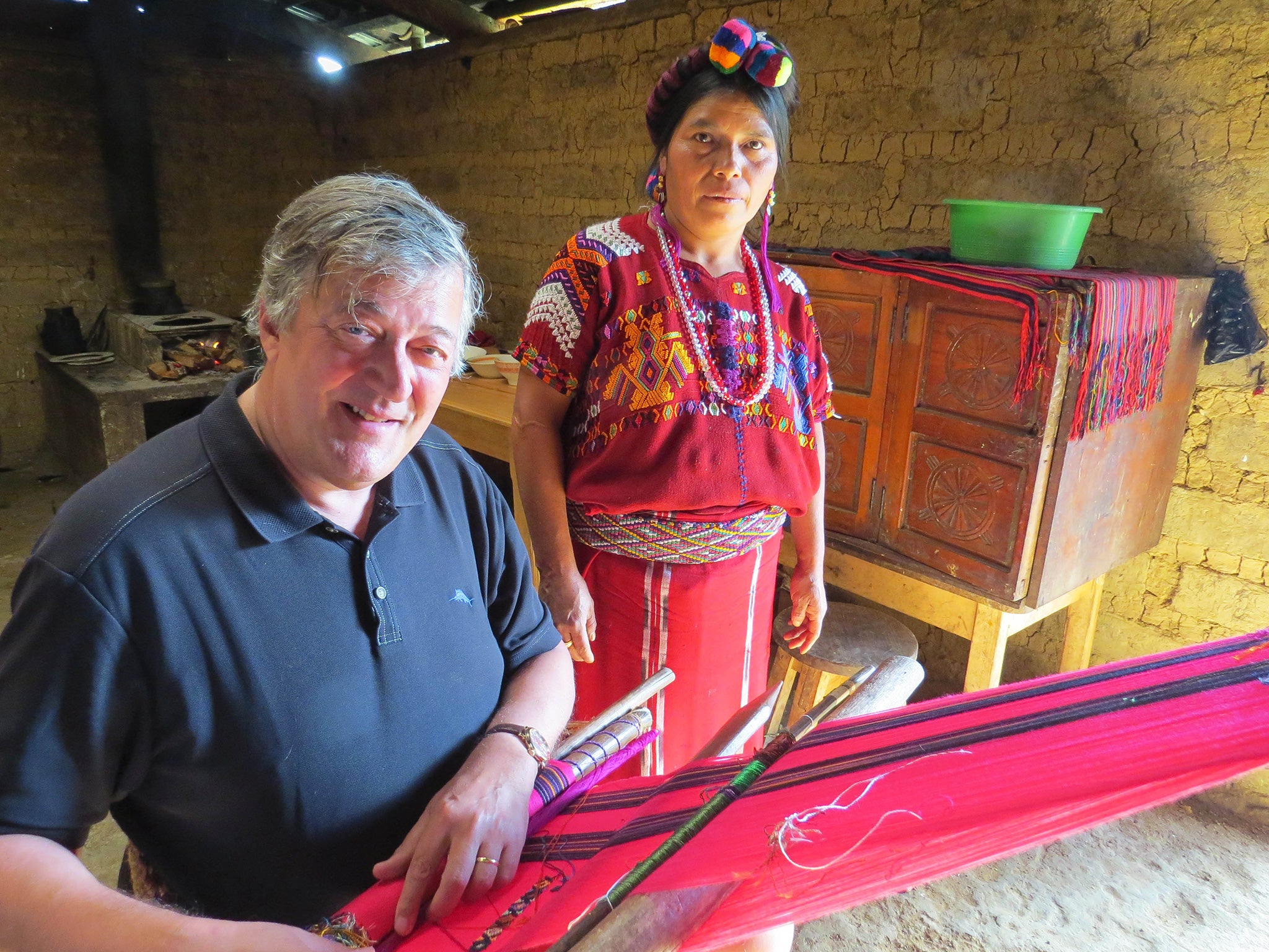 In stitches: Stephen Fry with weaver Catarina Caba in Chajul, Guatemala