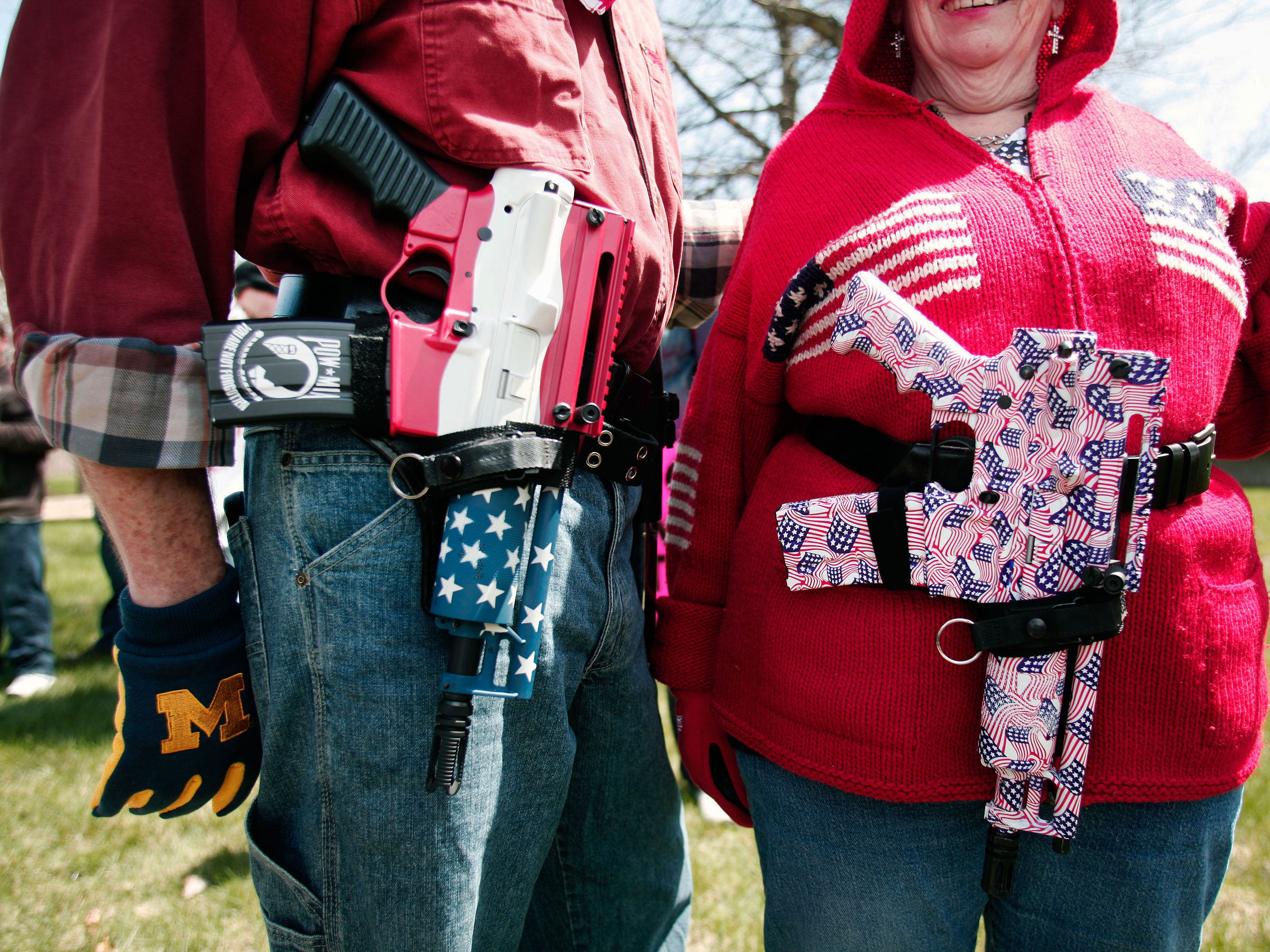 A couple show off their customised Olympic Arms OA93 pistols at a rally in Michigan for supporters of the right to openly carry guns in public.