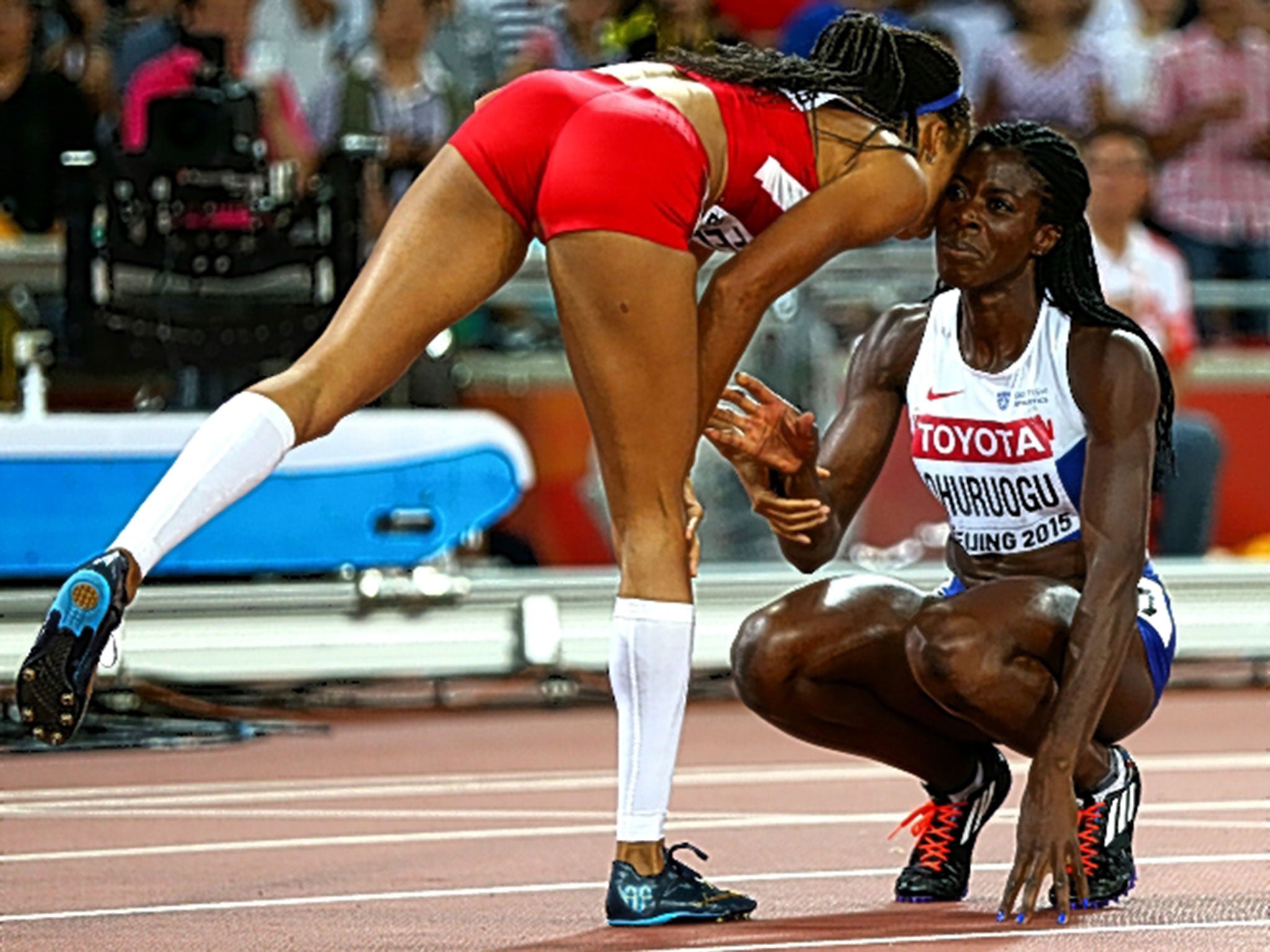 Gold medallist Allyson Felix consoles Christine Ohuruogu after the Briton came last in the 400m final in the Bird’s Nest