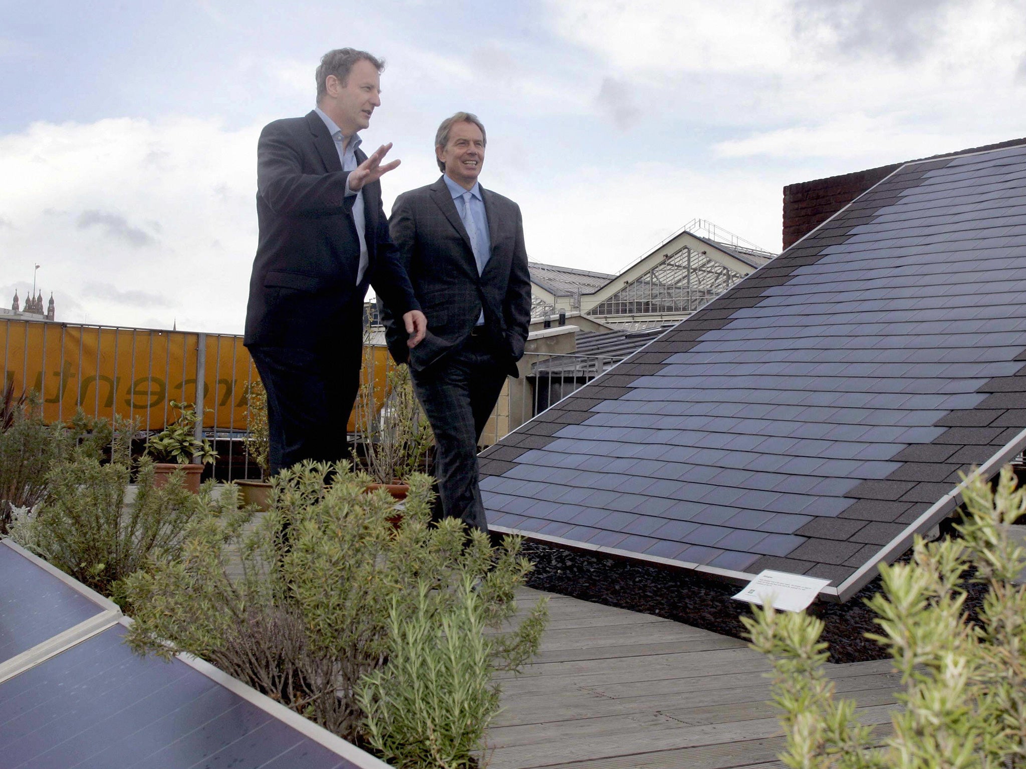 Ex-Prime Minister Tony Blair inspects solar roof panels at a time when the governent was more inclined to see them as a viable source of green energy