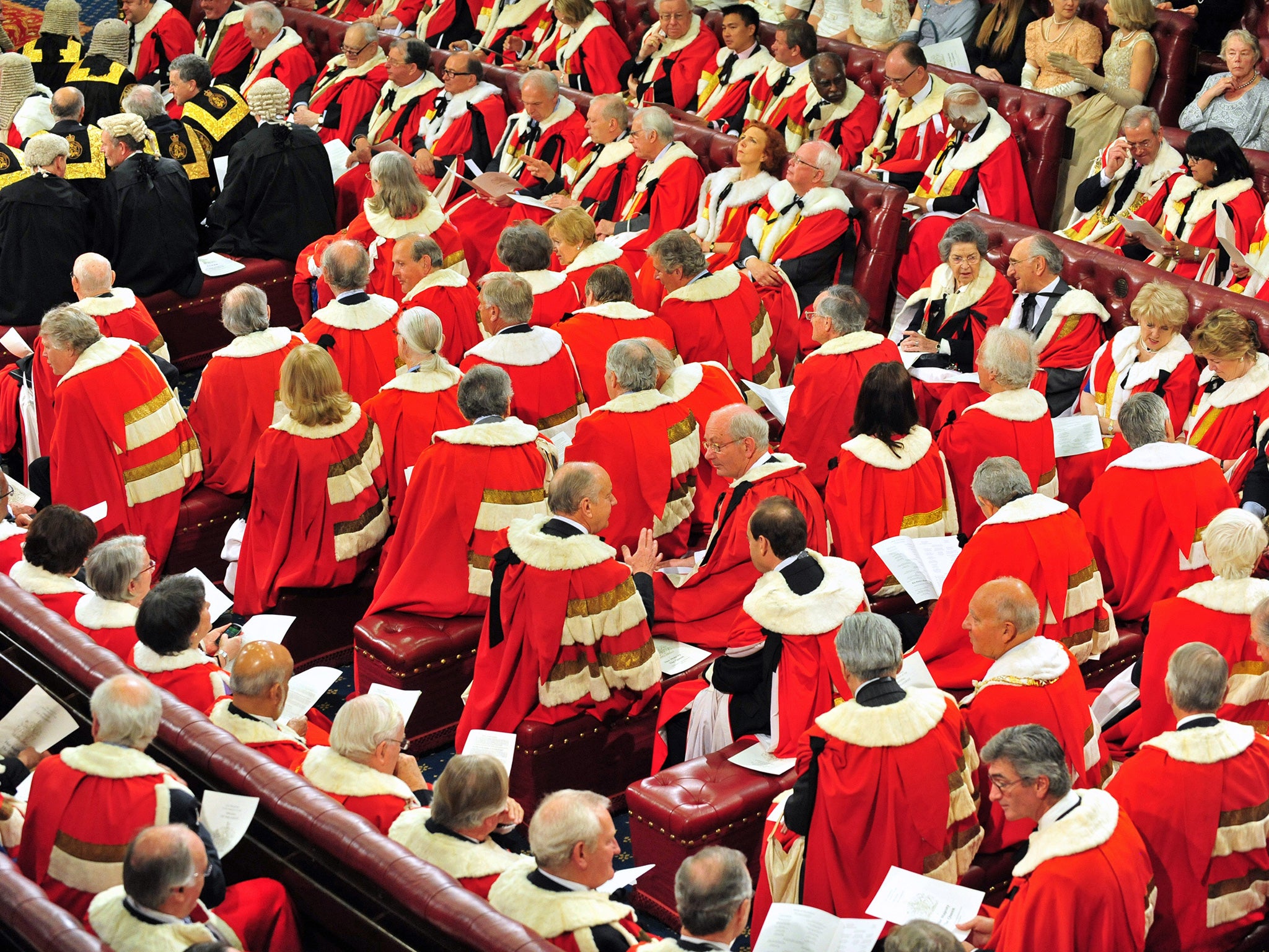 Peers and guests wait in the House of the Lords as Britain's Queen Elizabeth II arrives to deliver a speech during the State Opening of Parliament