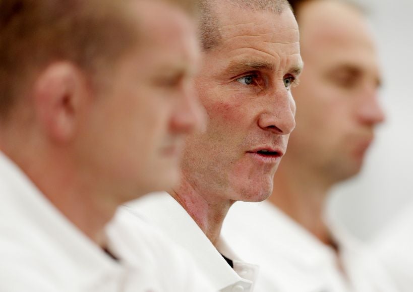 England coach Stuart Lancaster flanked by coaches Graham Rowntree (left) and Mike Catt, explains the reasons behind his England squad choices yesterday