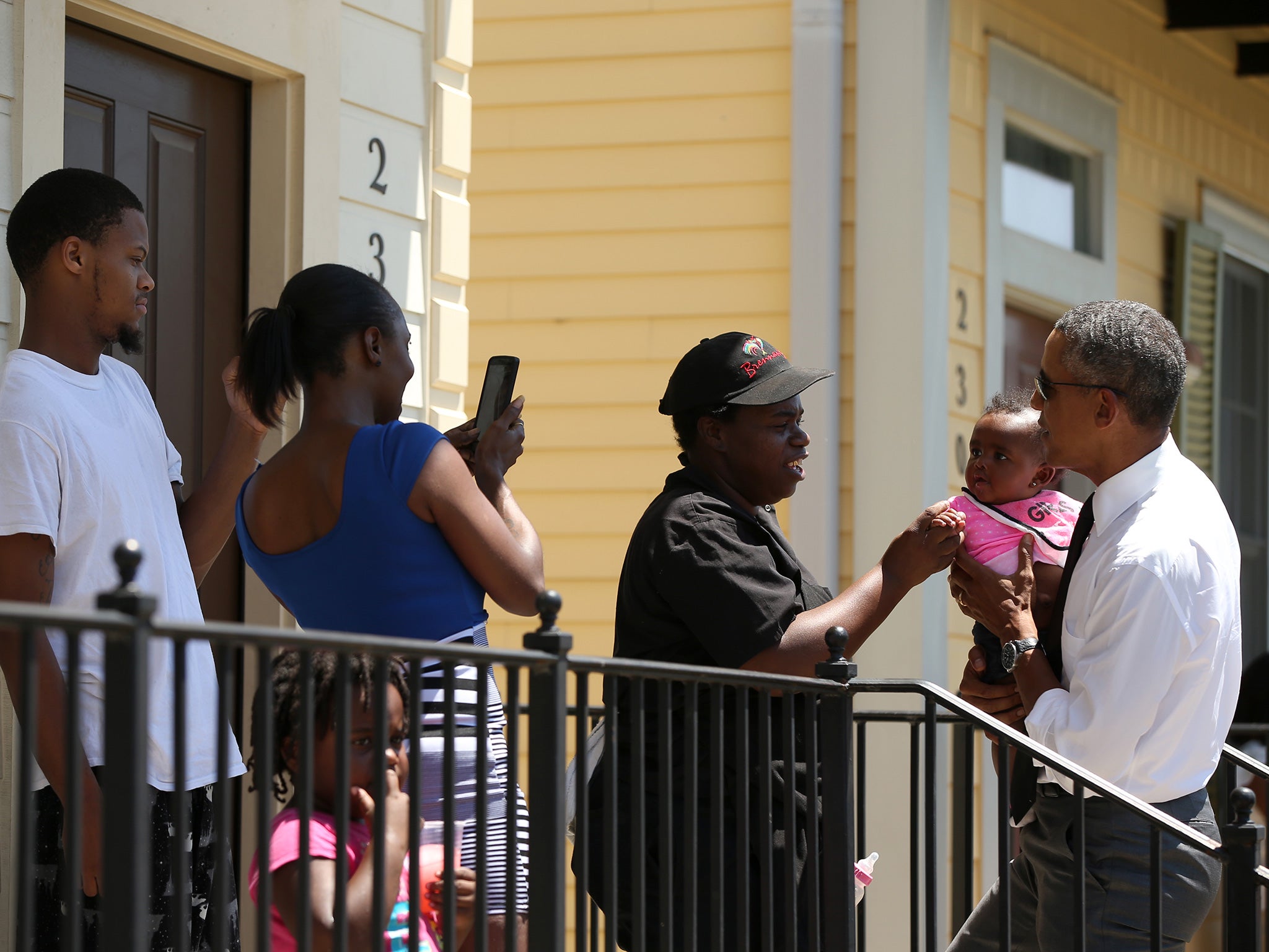 Barack Obama meets residents of the New Orleans district of Tremé, one of America’s oldest black suburbs, as he walks through the city yesterday to see how it has has recovered in the 10 years since Hurricane Katrina.