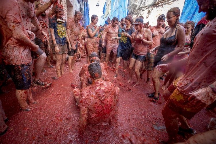 Revellers throw tomato pulp at each other during the annual "tomatina" festivities in the village of Bunol, near Valencia