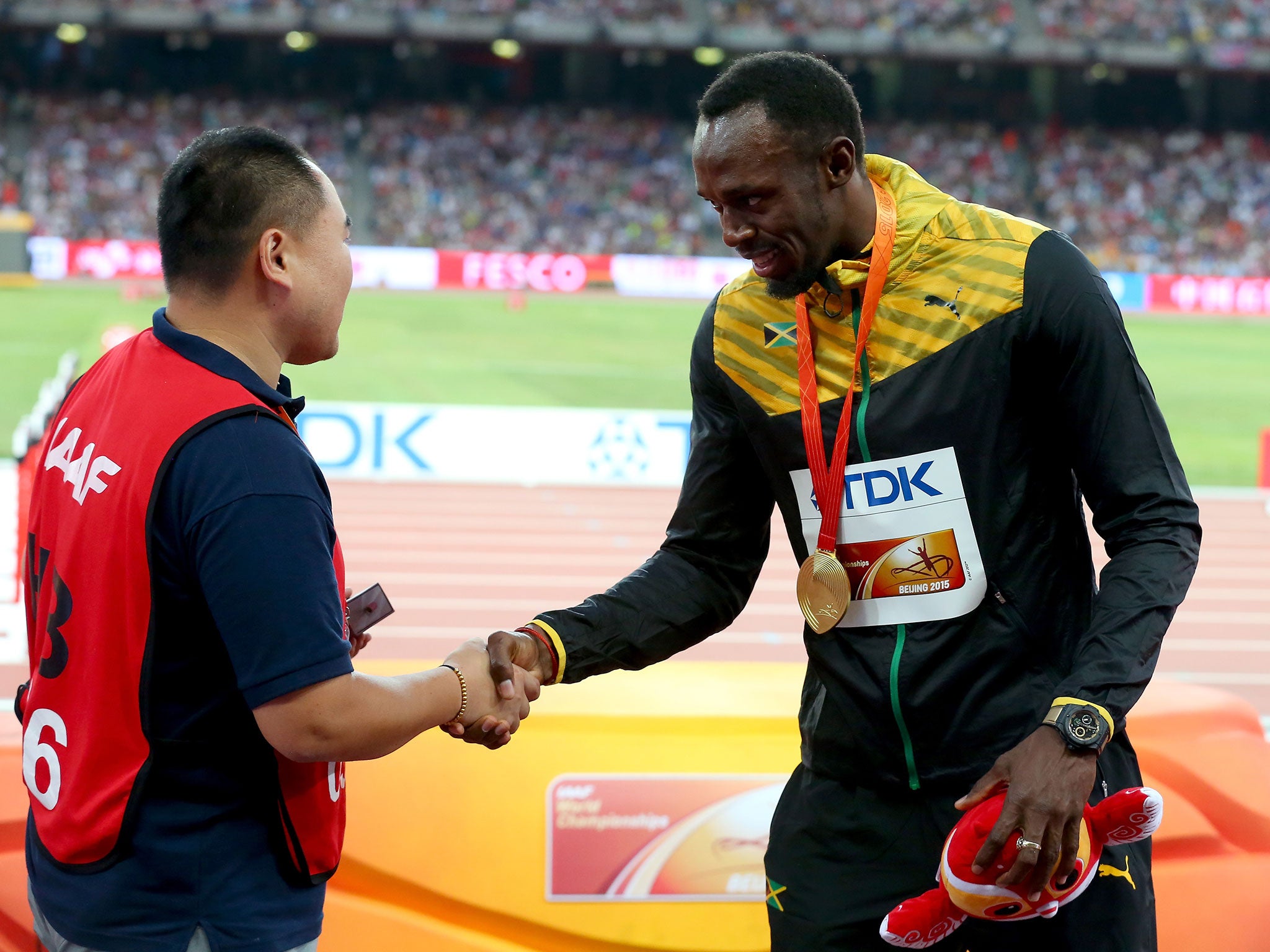 The pair shake hands after Bolt received his medal