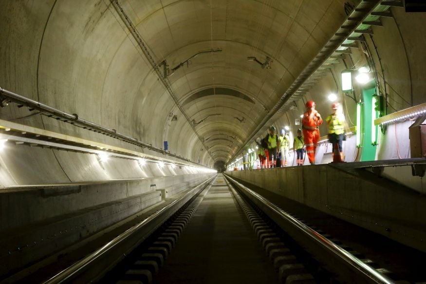 Journalists walk at a multifunction and emergency stop station of the NEAT Gotthard Base Tunnel during a media visit near the town of Sedrun August 24, 2015. Crossing the Alps, the world's longest train tunnel should become operational at the end of 2016,