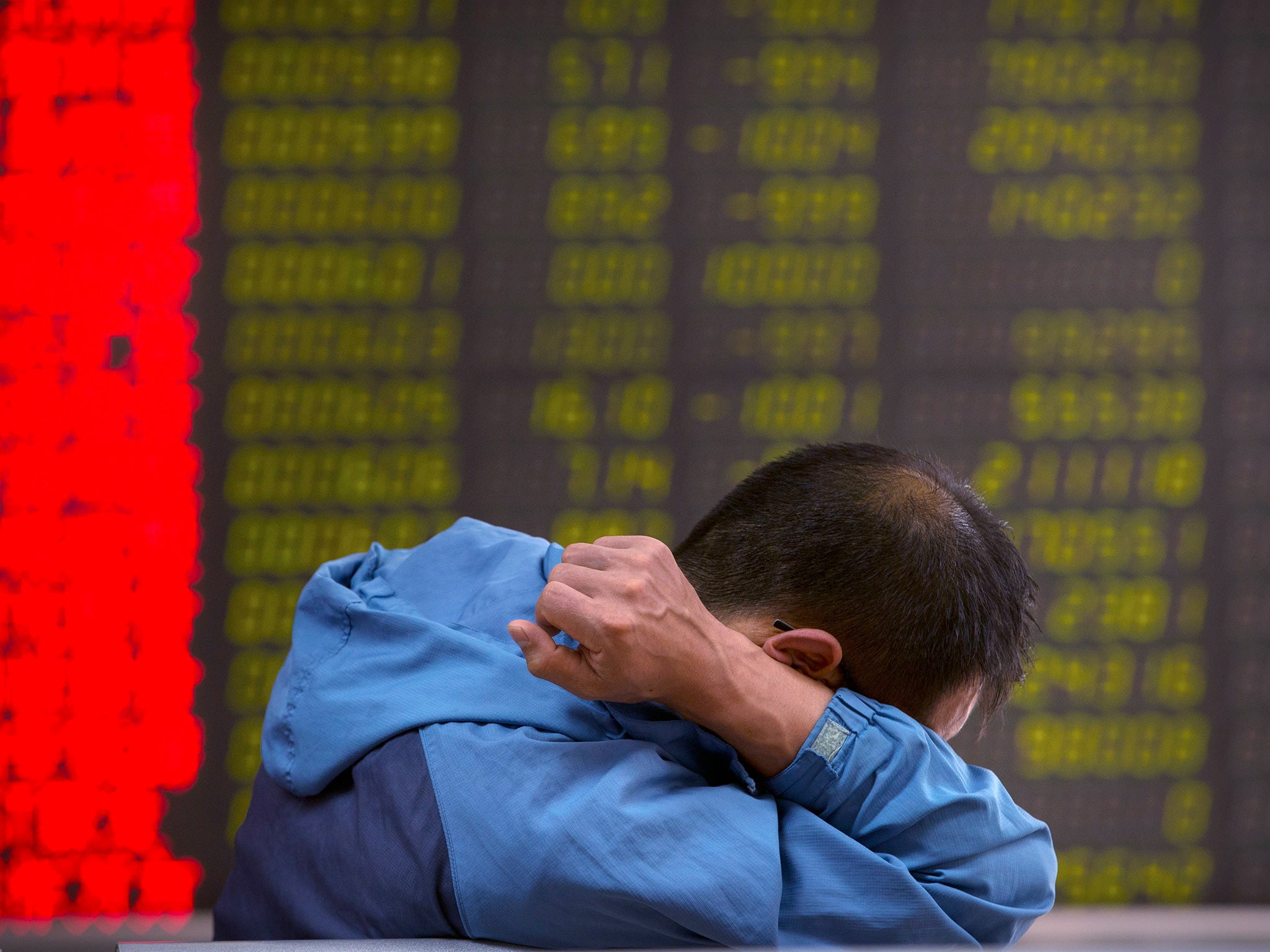 A Chinese investor monitors stock prices at a brokerage house in Beijing, Tuesday, 25 August, 2015