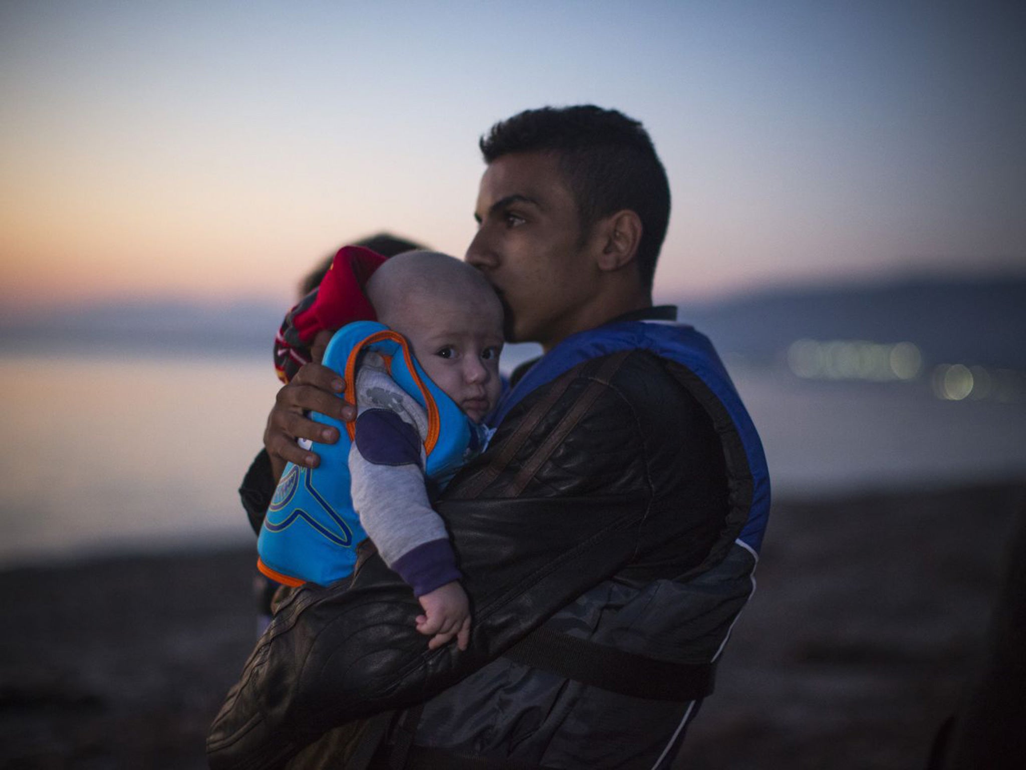 Two of the Syrian migrants who arrived by inflatable dinghy on Kos island from Turkey yesterday, at dawn