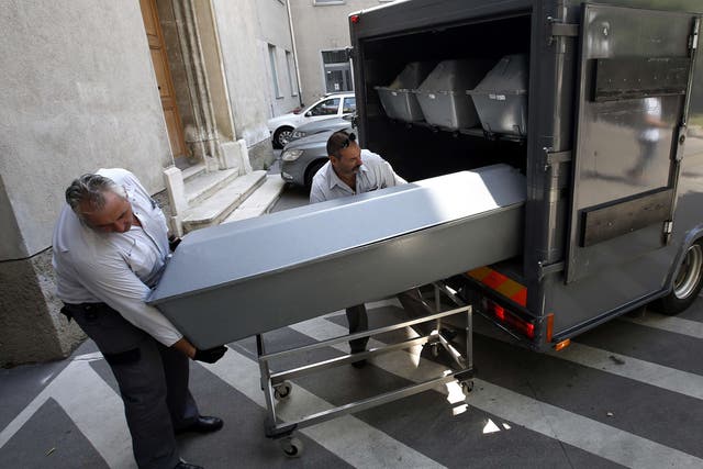 Coffins containing the bodies of migrants found dumped on an Austrian motorway this week are unloaded at the forensics institute in Vienna yesterday. Three people have been arrested 
