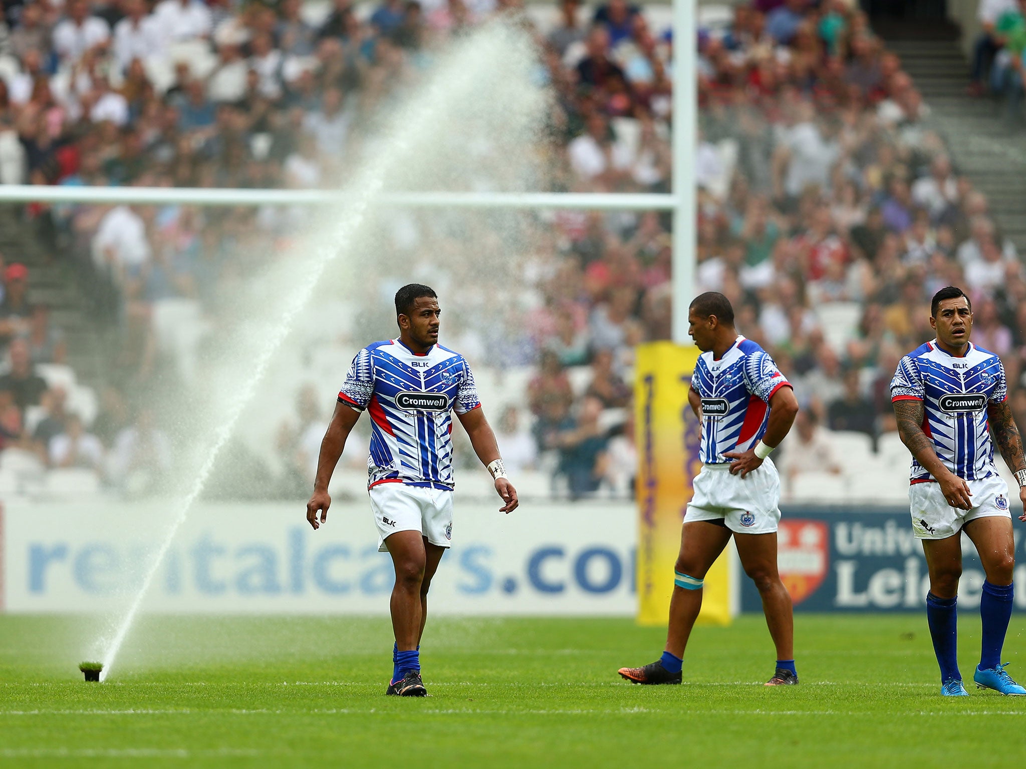 The sprinklers come on during the Barbarians vs Samoa at the Olympic Stadium