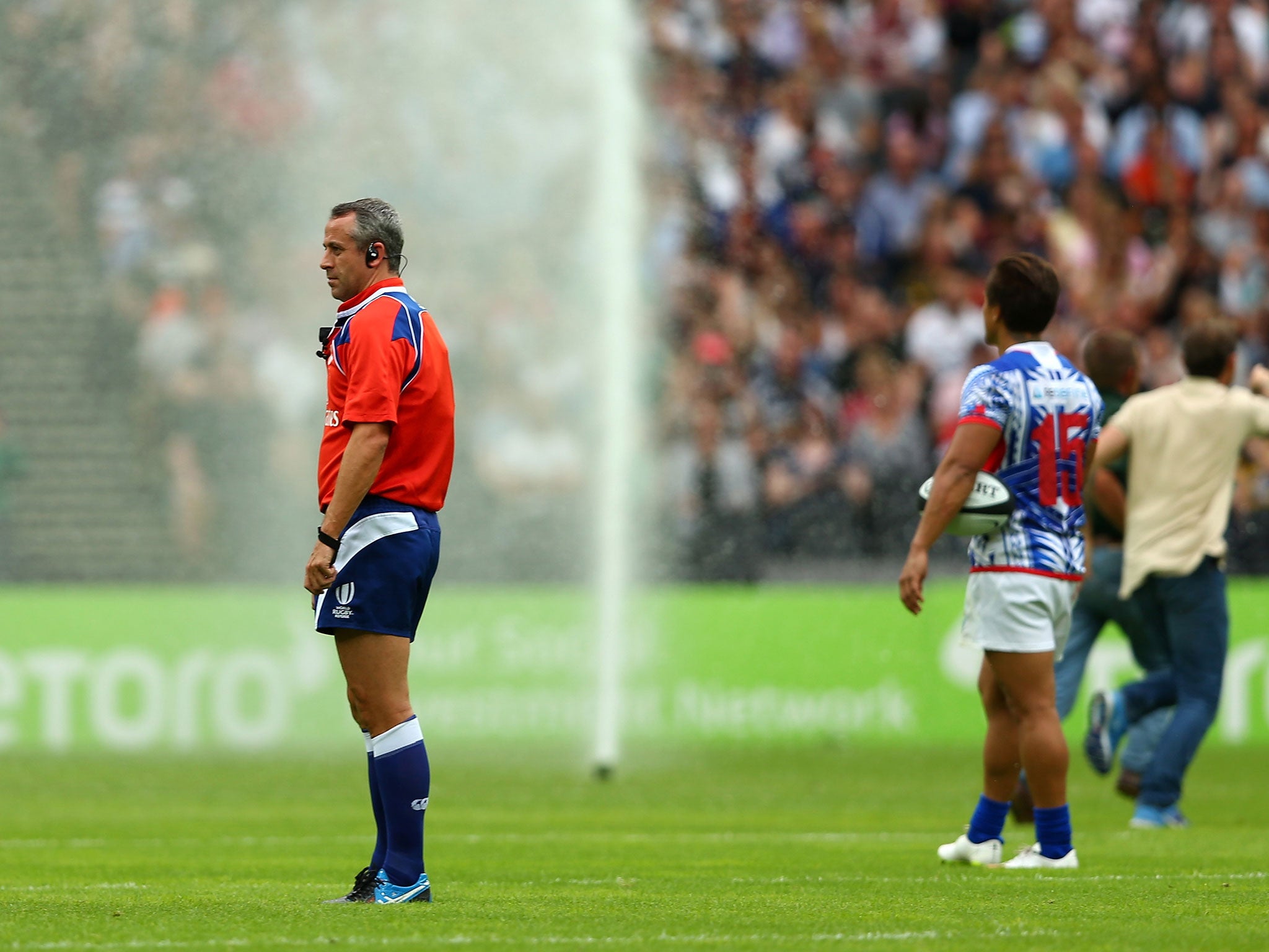 The sprinklers come on during the Barbarians vs Samoa at the Olympic Stadium