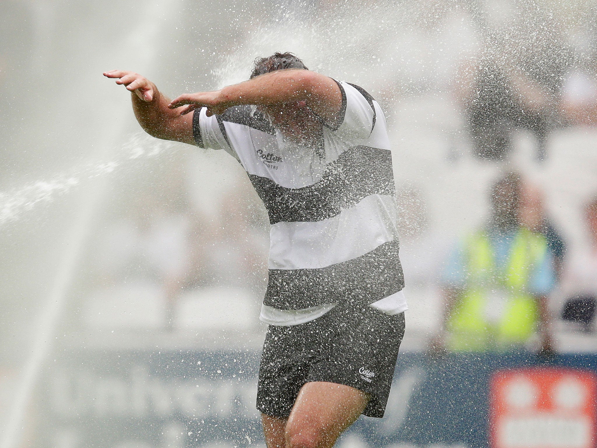 Carl Hayman unsuccessfully tries to avoid the sprinklers