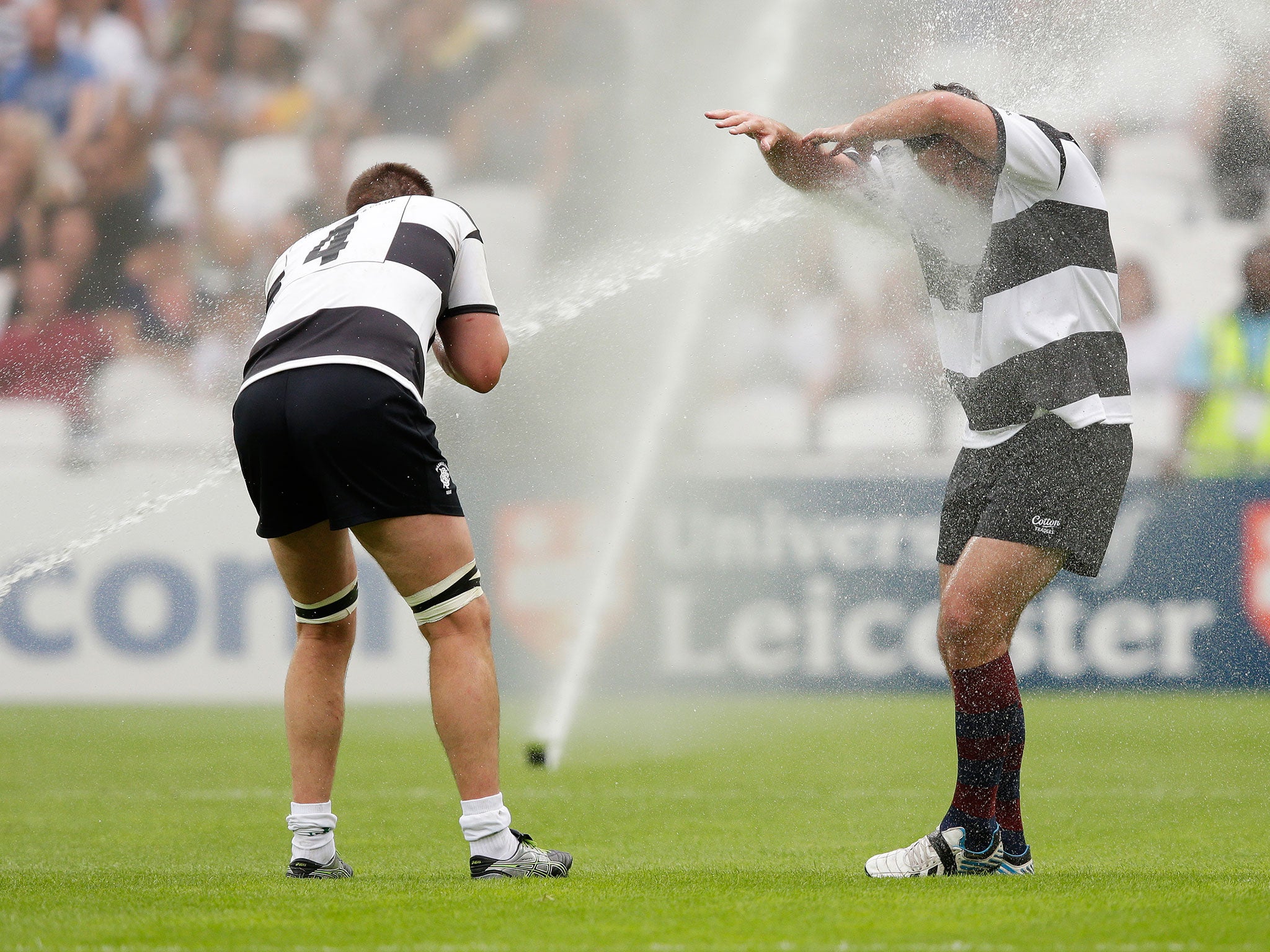 Bakkies Botha and Carl Hayman are soaked by the sprinklers