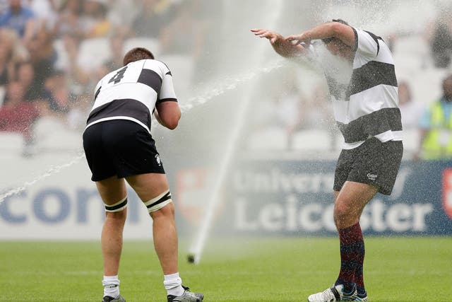 Bakkies Botha and Carl Hayman are soaked by the sprinklers