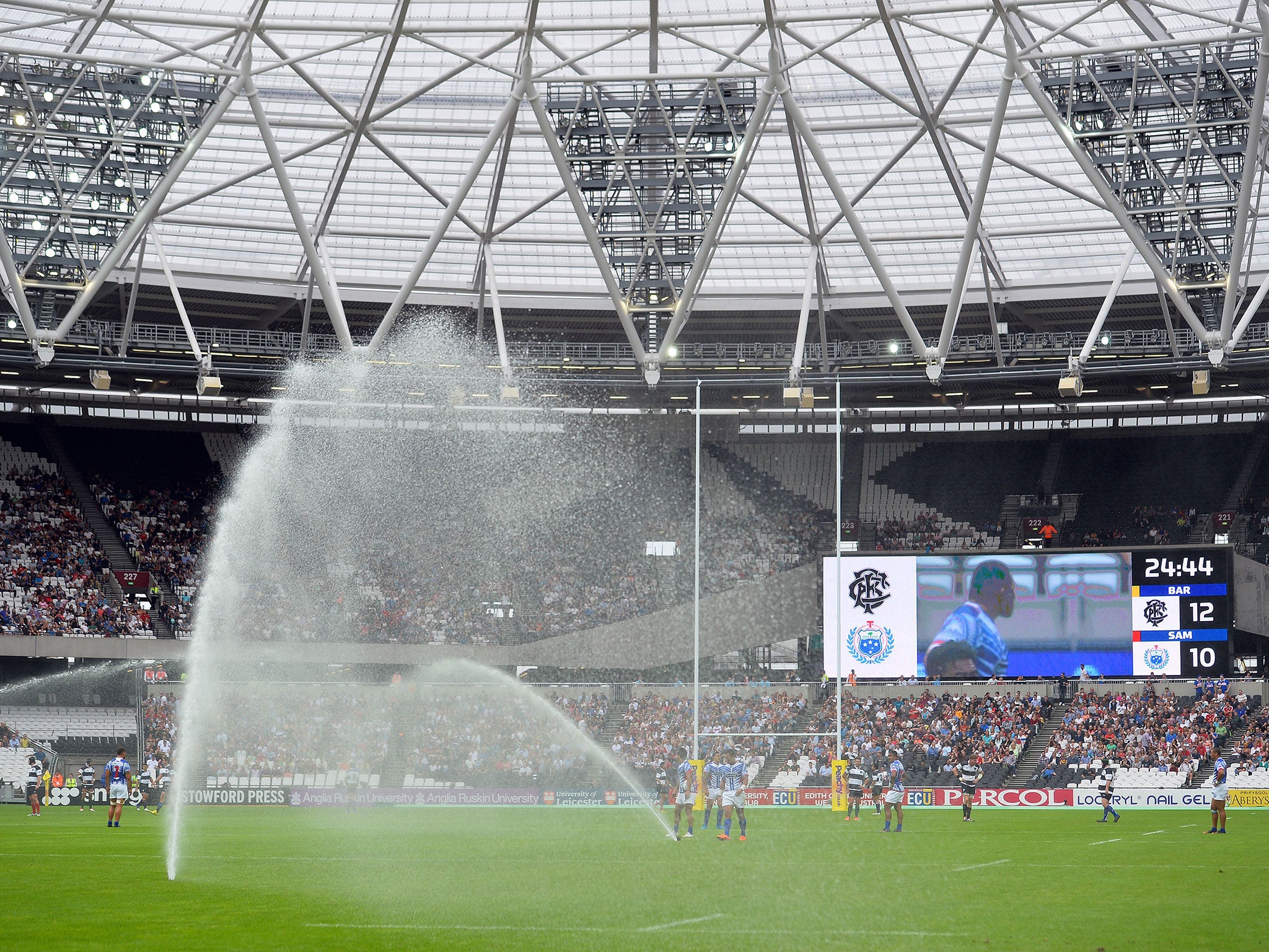 The sprinklers turn on at the Olympic Stadium