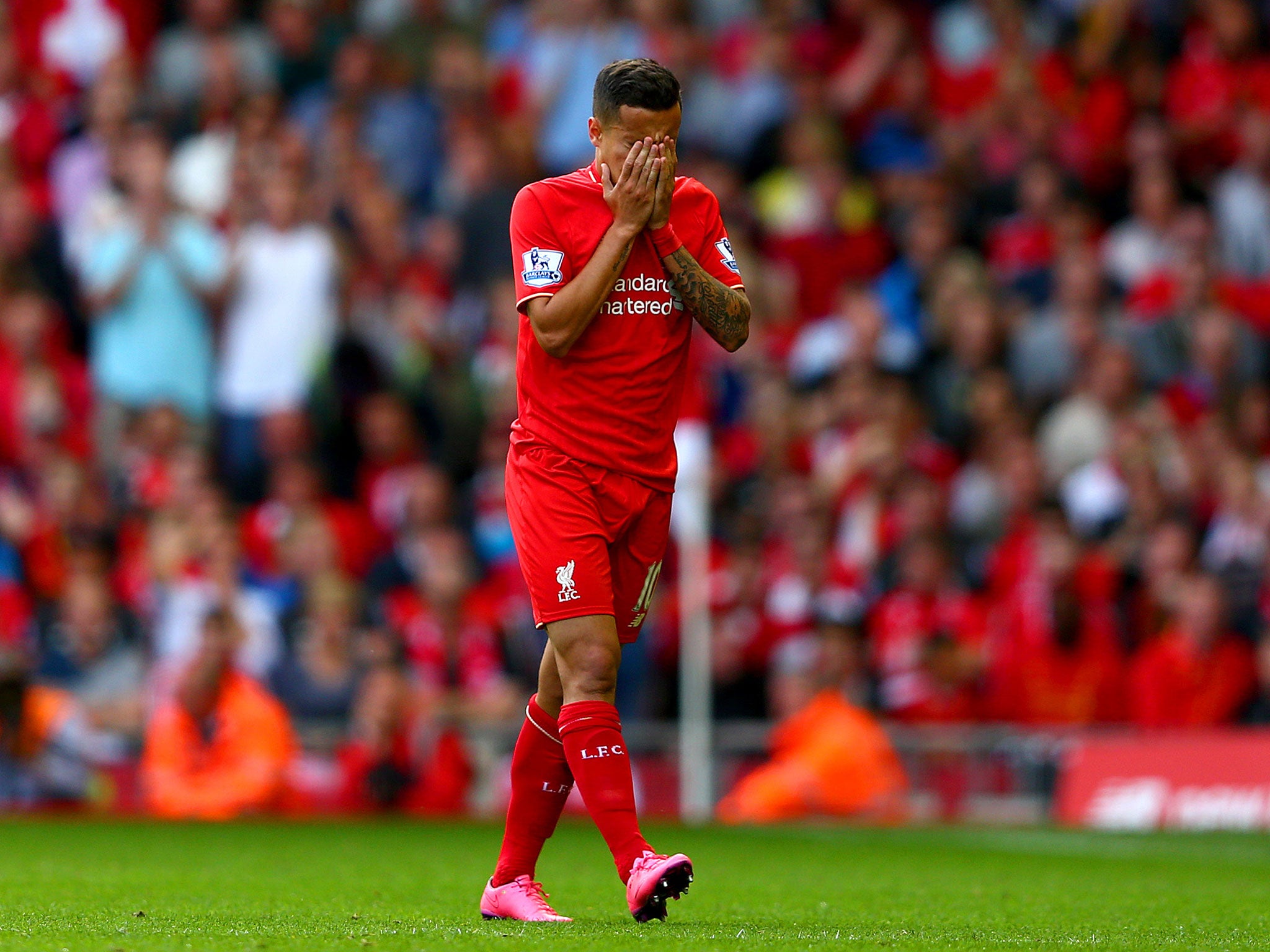 Philippe Coutinho dejectedly walks off after being shown a red card