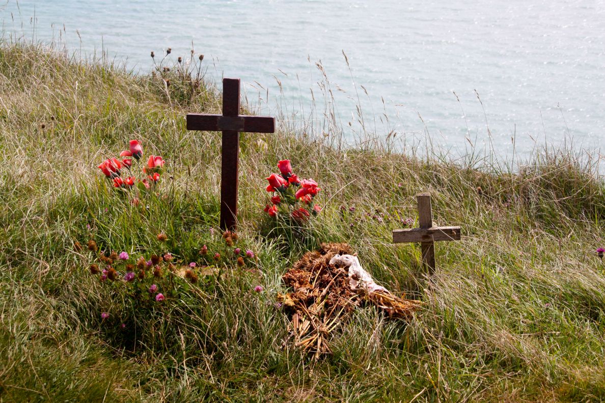 Shrine of cross and flowers at Beachy Head cliff top the third most used suicide spot in the world