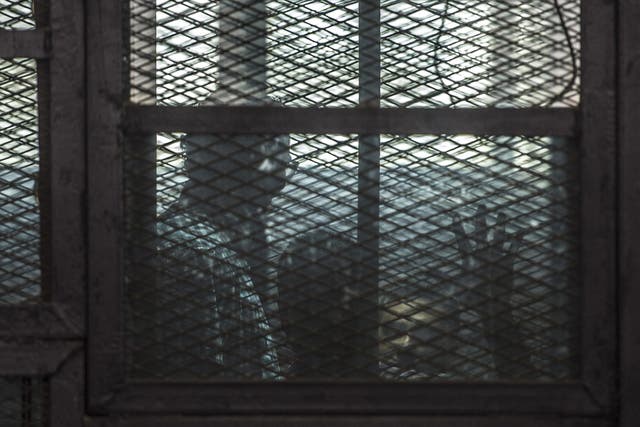 The accused behind glass in court in 2014