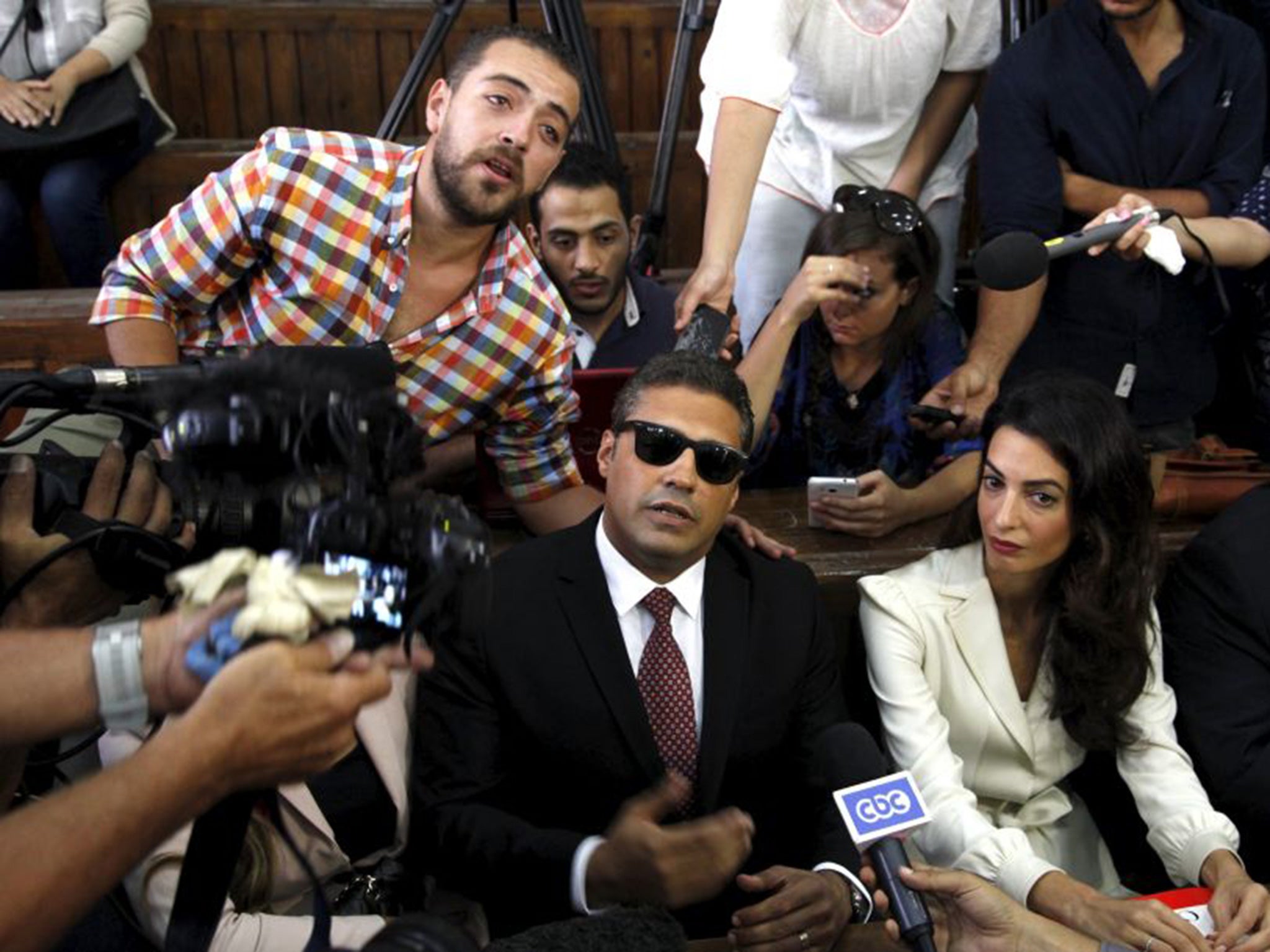 Mohamed Fahmy and Baher Mohamed (left) with their lawyer Amal Clooney