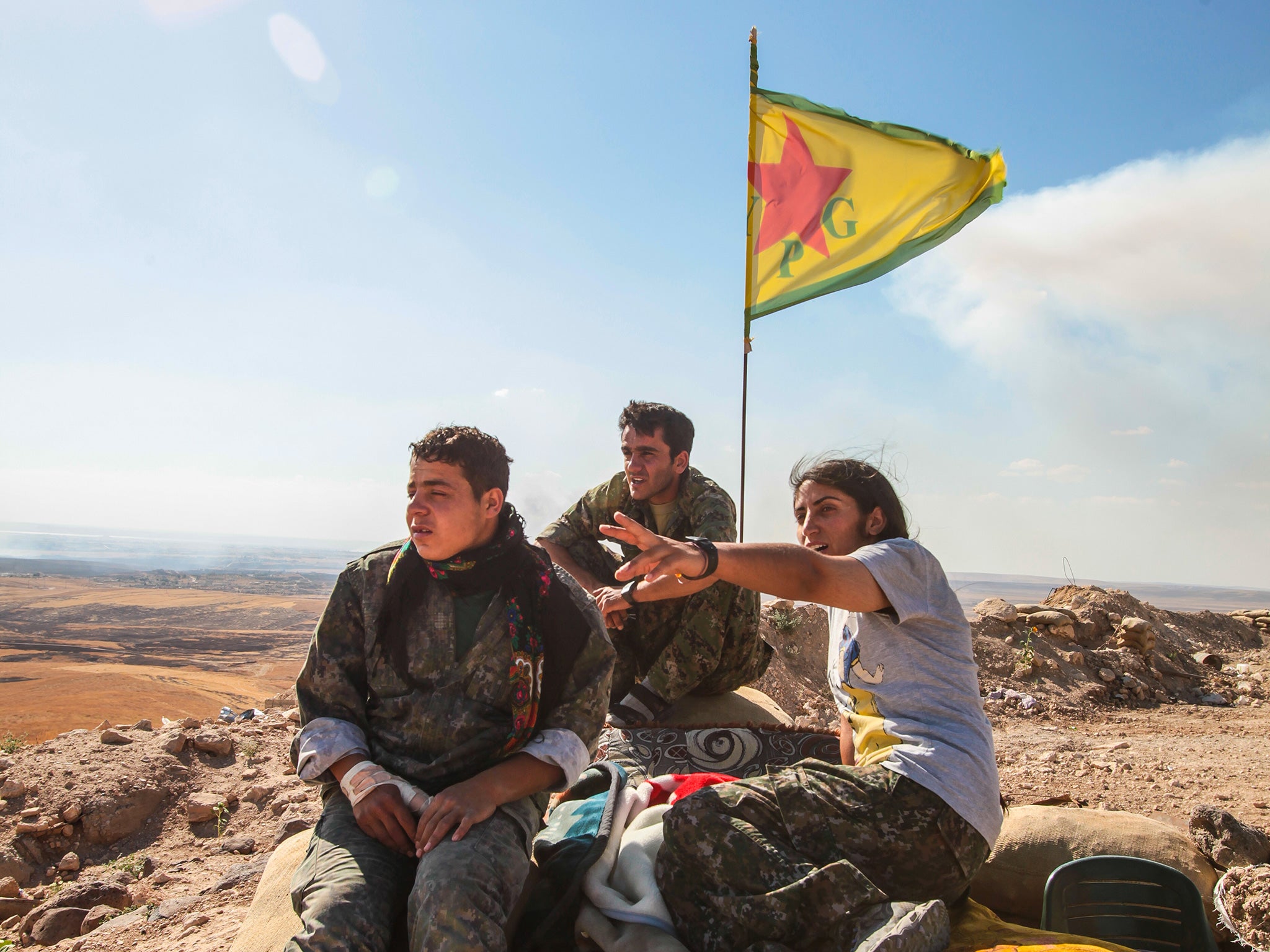 YPG fighters stand guard near Kobane, Syria. Turkey claims the group is too closely linked with the outlawed PKK
