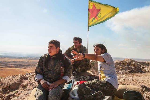 YPG fighters stand guard near Kobane, Syria. Turkey claims the group is too closely linked with the outlawed PKK
