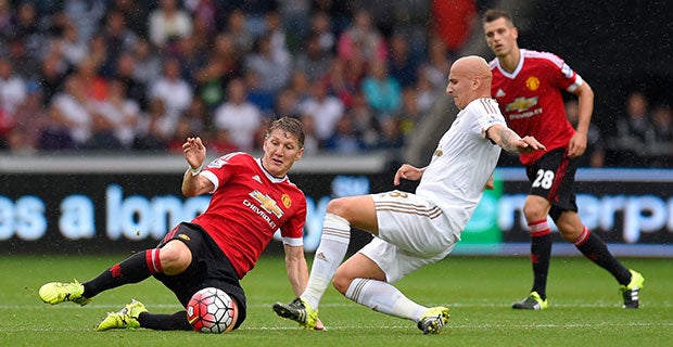 Bastian Schweinsteiger goes into a tackle with Jonjo Shelvey