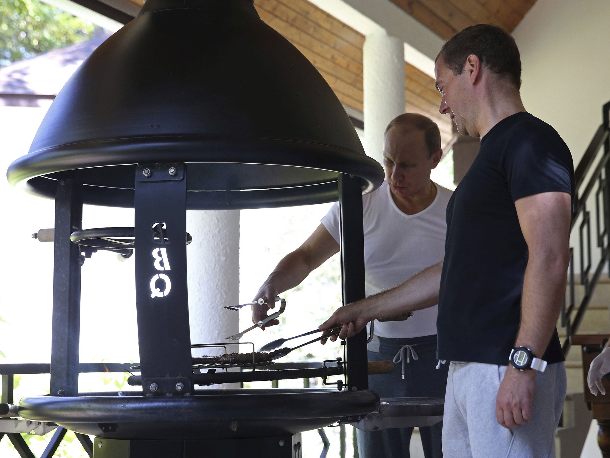 Putin and Medvedev grill meat after their workout