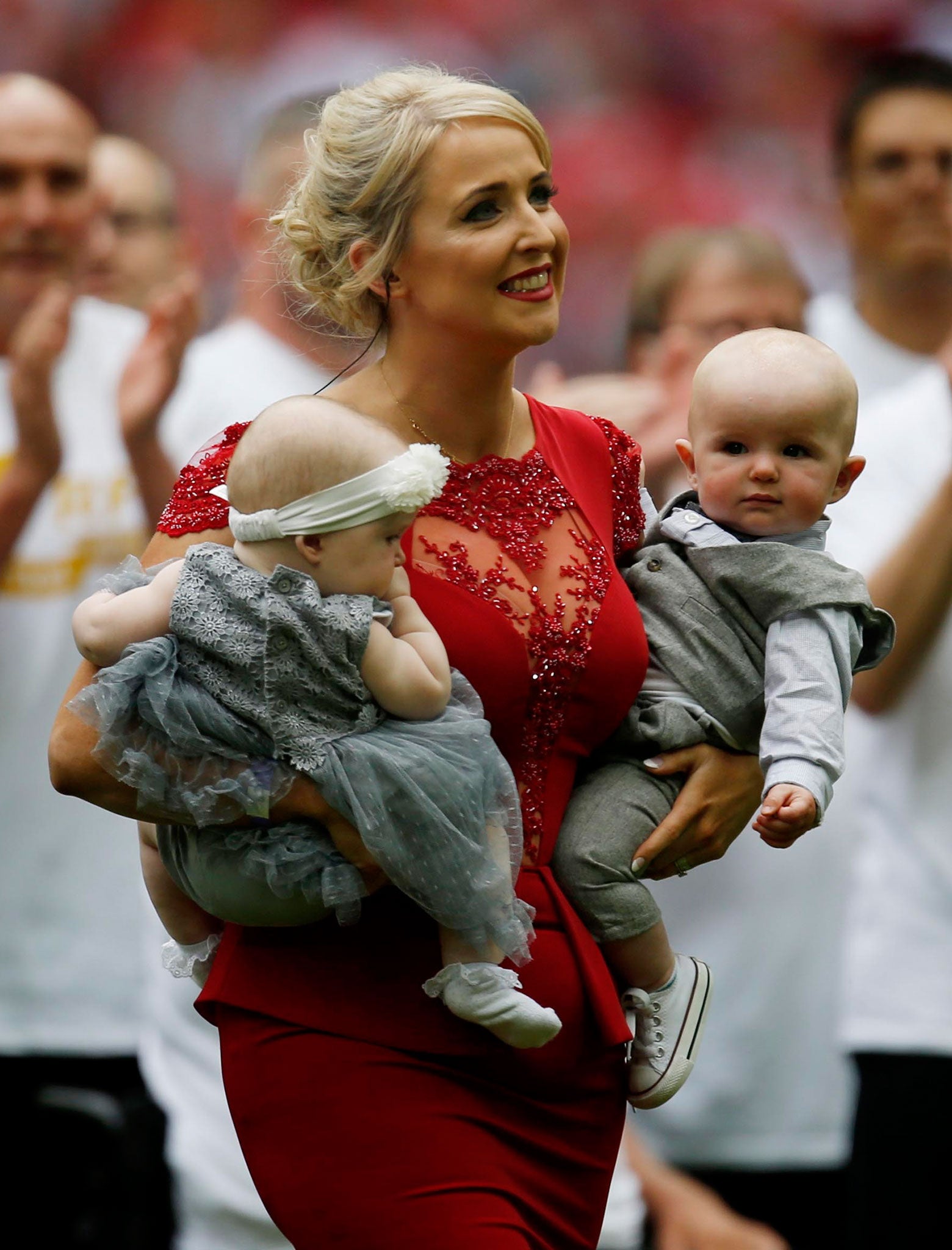 Lizzie Jones, widow of rugby player Danny Jones, with their twin children after her performance of 'Abide With Me' at Wembley Stadium