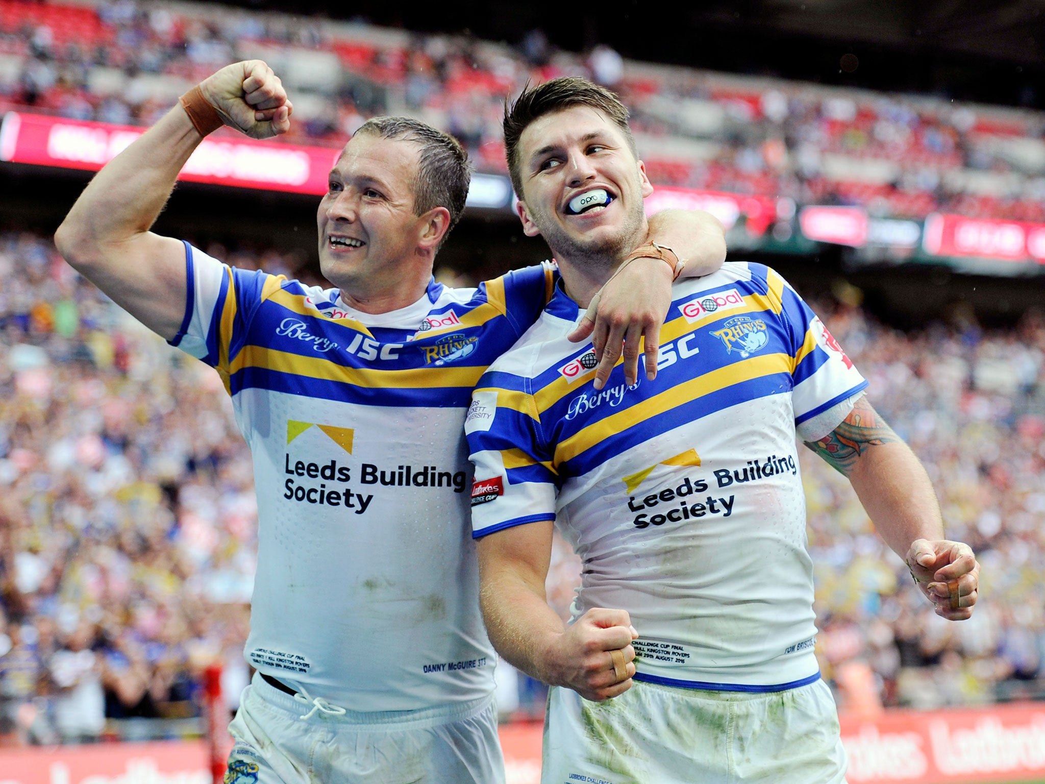 Leeds’ Tom Briscoe, right, celebrates scoring one of his record five tries with Danny McGuire